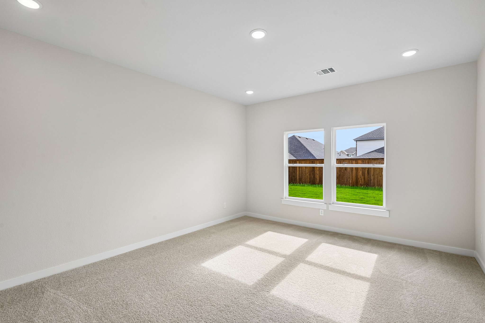 A room with a window and a tile floor.