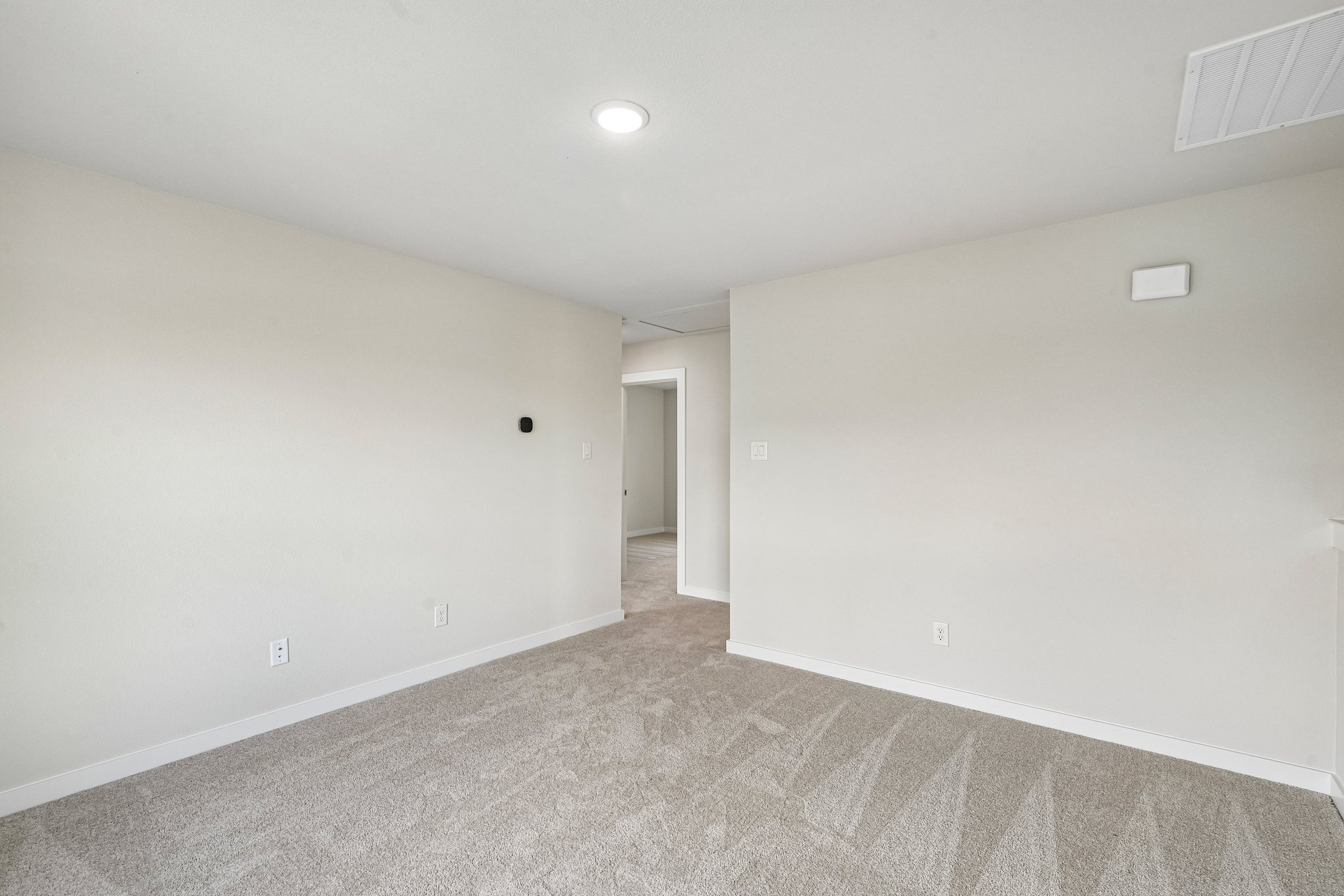 A hallway with white walls.
