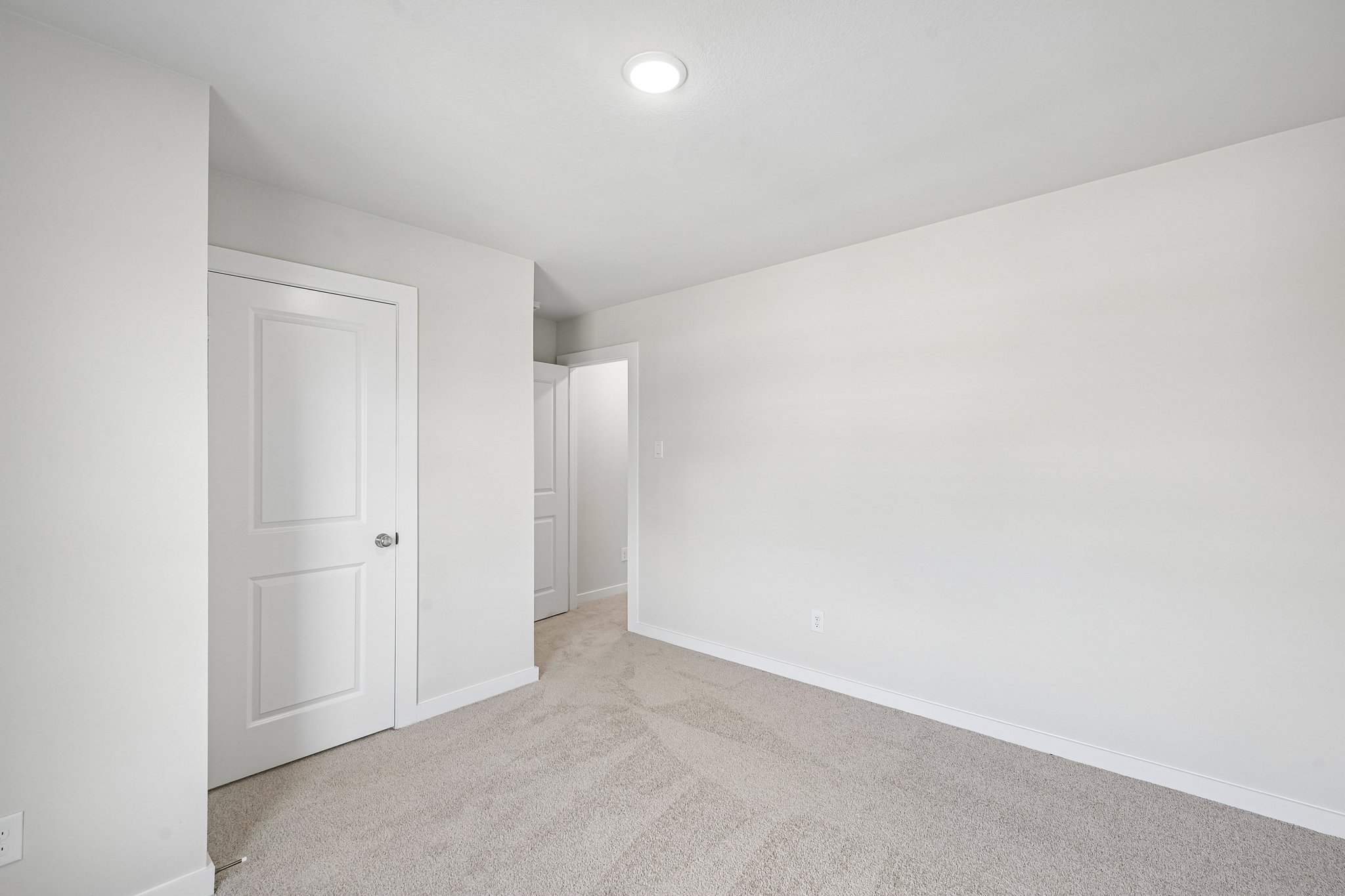 A hallway with white doors.