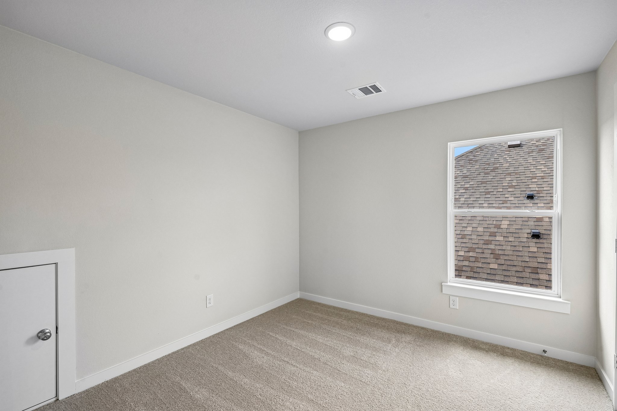 A room with a window and a door.