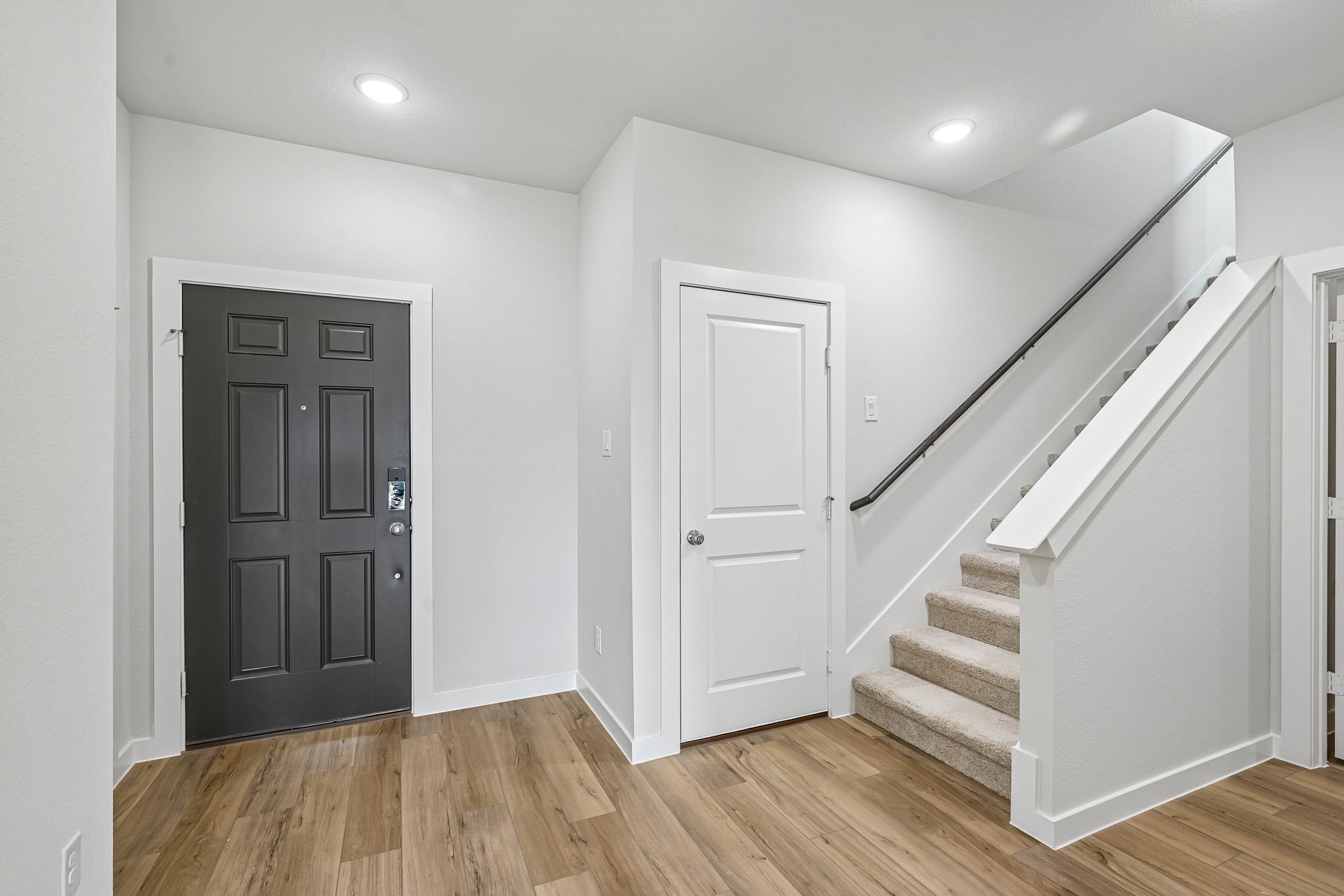 A staircase with white doors.