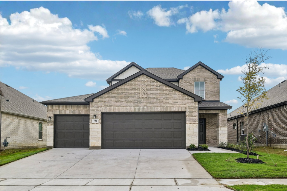 A house with garages and a driveway.