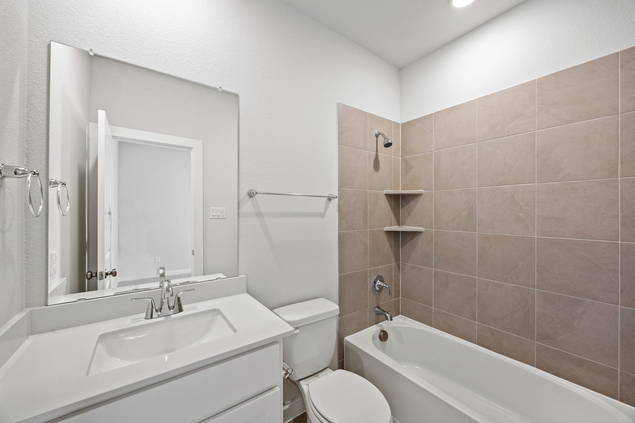 A bathroom with a tub sink and toilet.