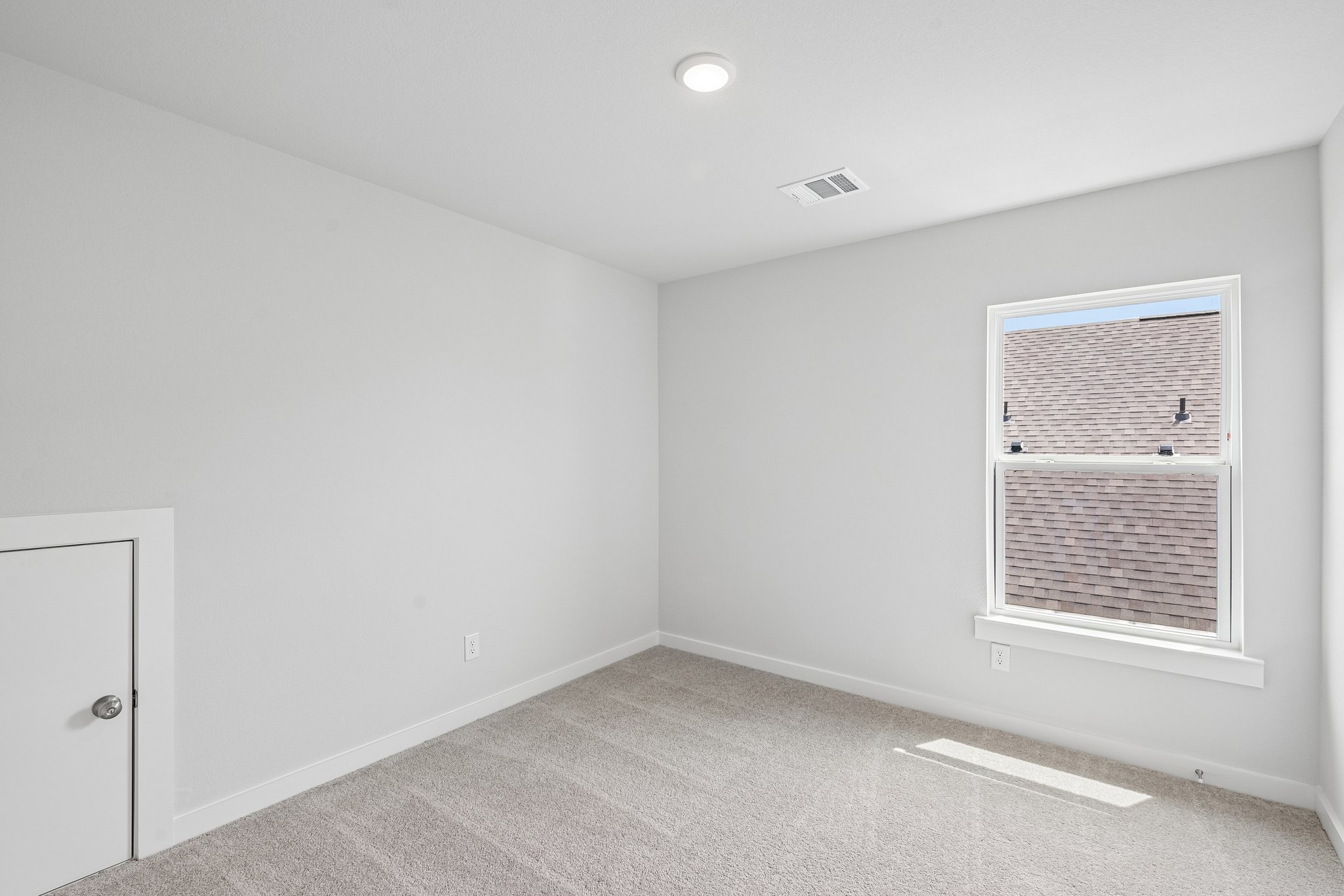 A room with a window and a door.