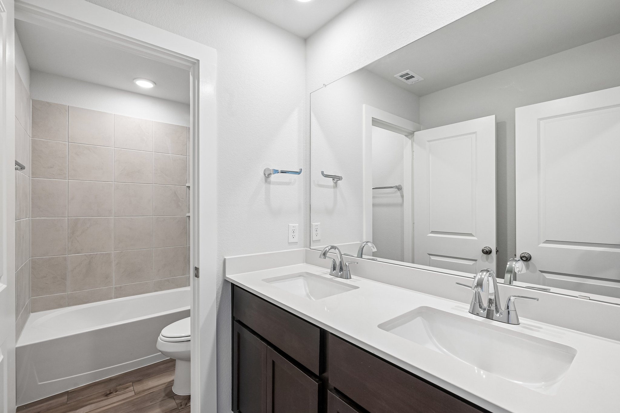 A bathroom with a tub sink and toilet.