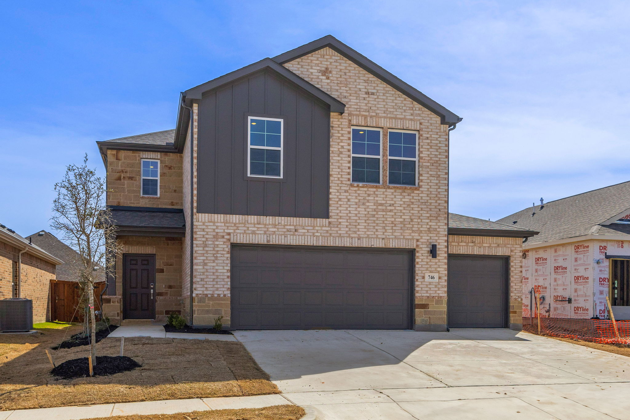 A house with garages and a driveway.