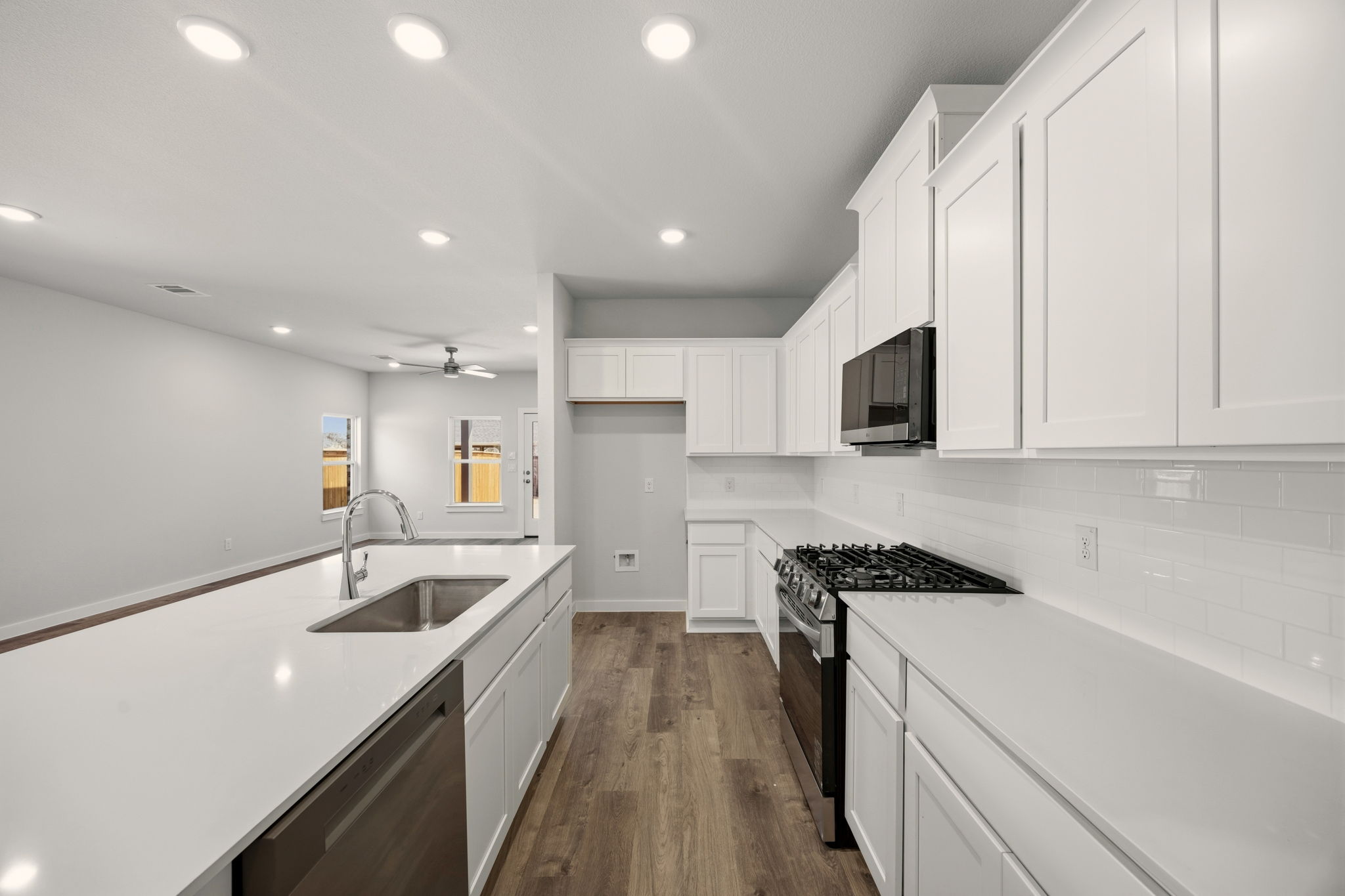 A kitchen with white cabinets.