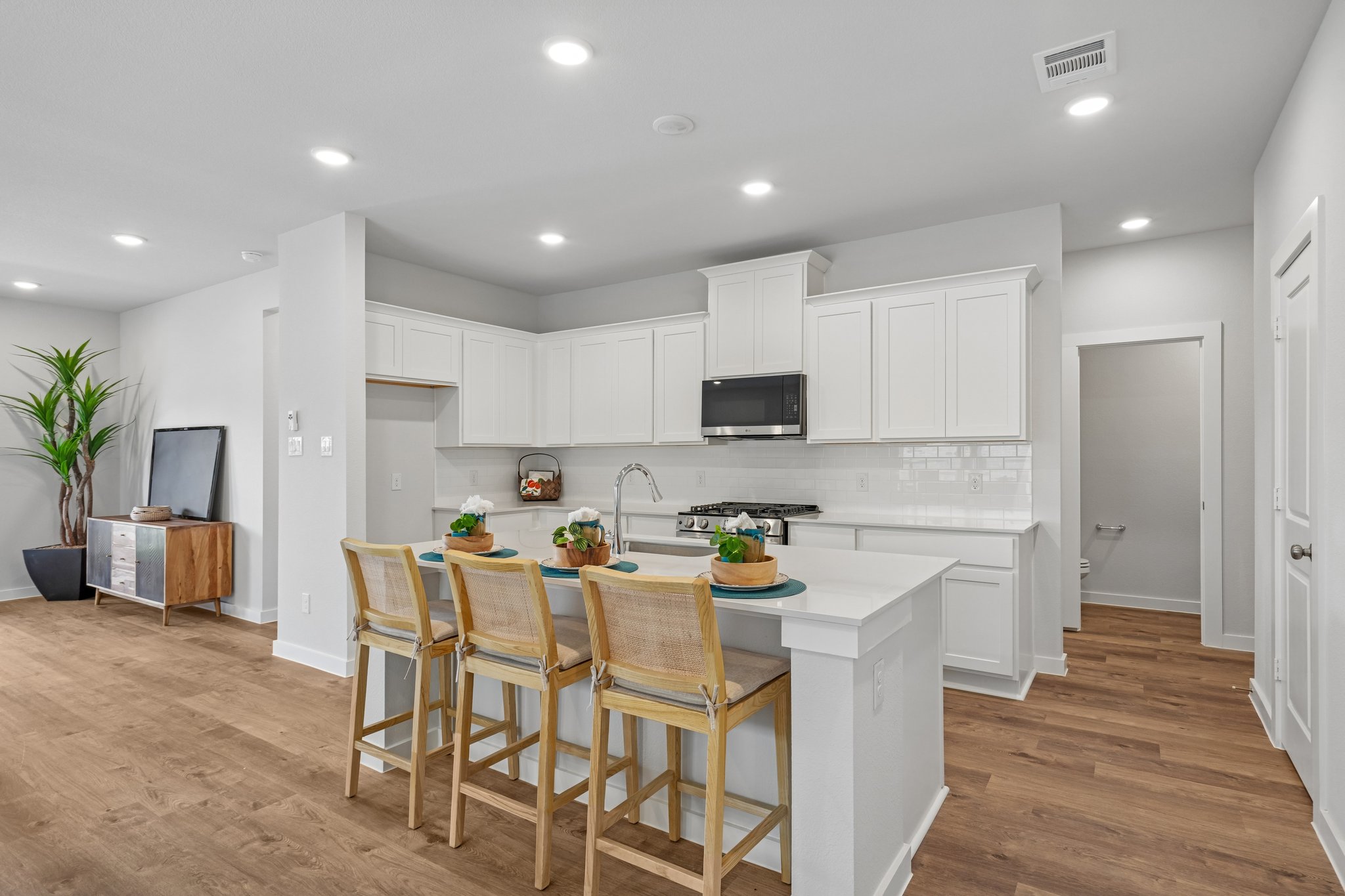 A kitchen with white cabinets.
