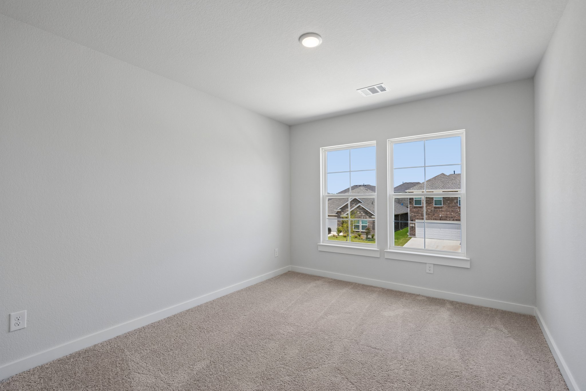 A room with a window and a carpet.
