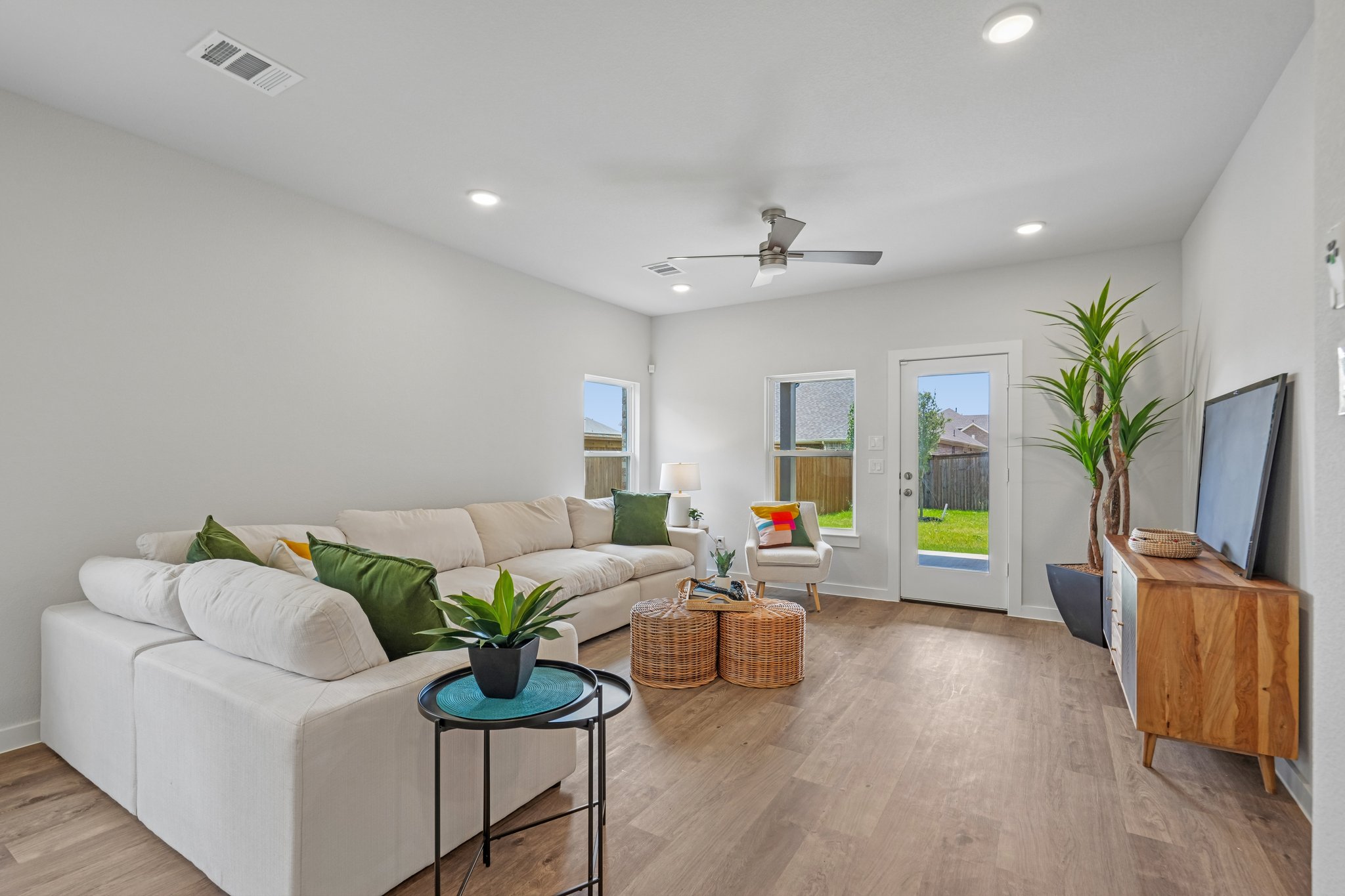 A living room with a white couch and a table.