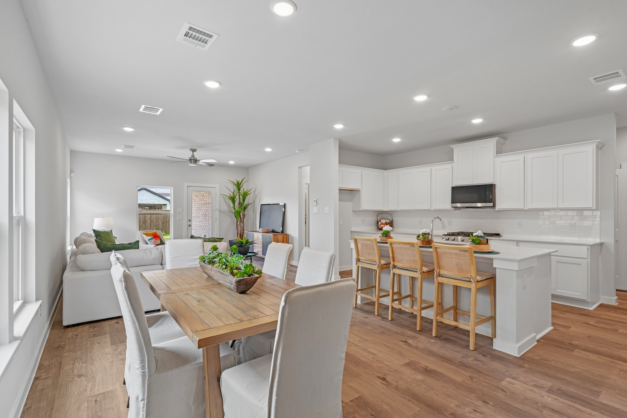 A large kitchen with a dining table.