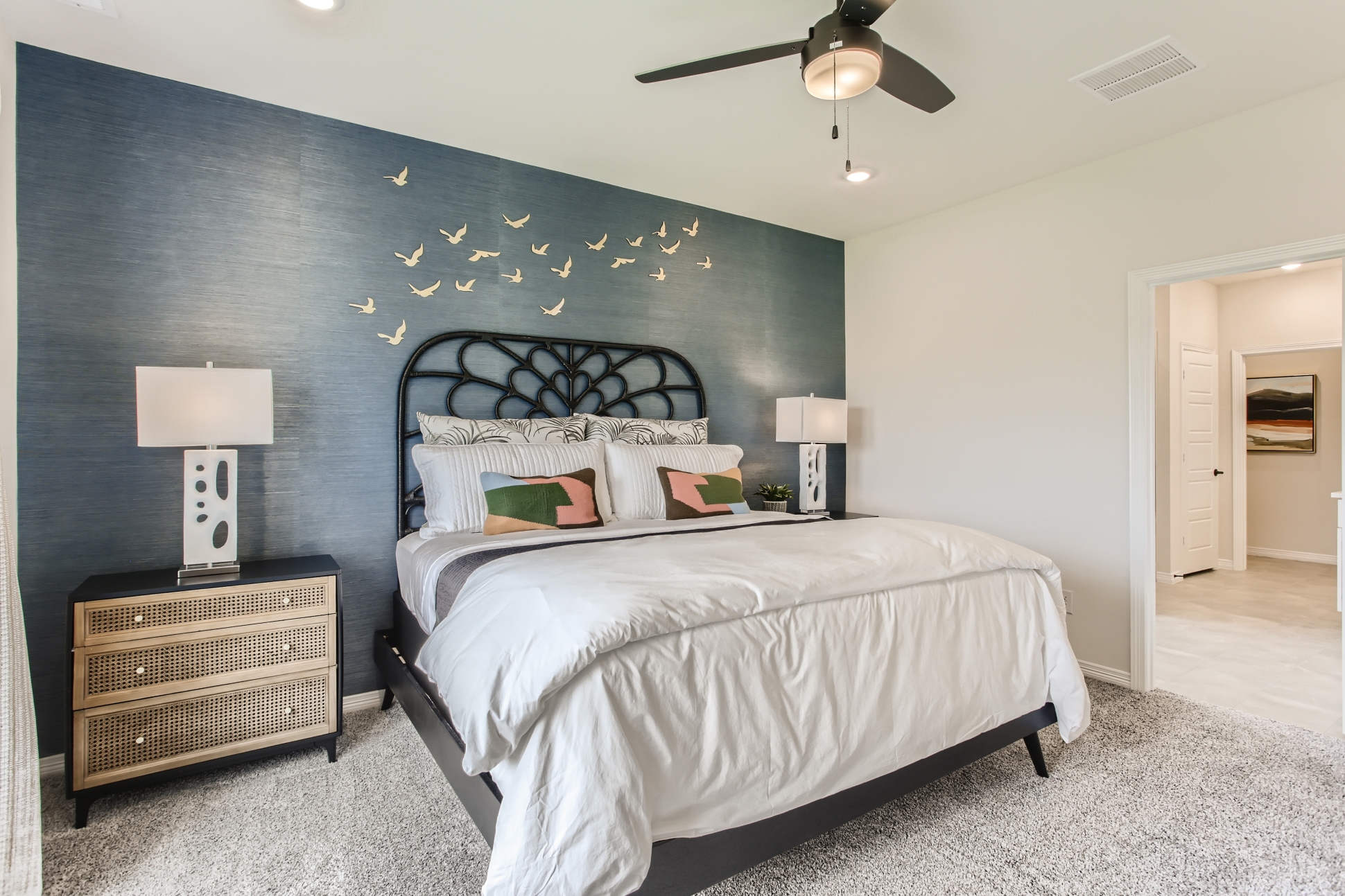 A bedroom with a bed and a fan.