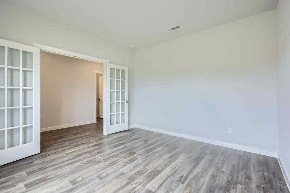A room with a wood floor and a wood floor.