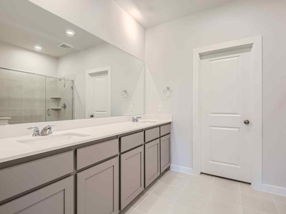 A bathroom with a large mirror.