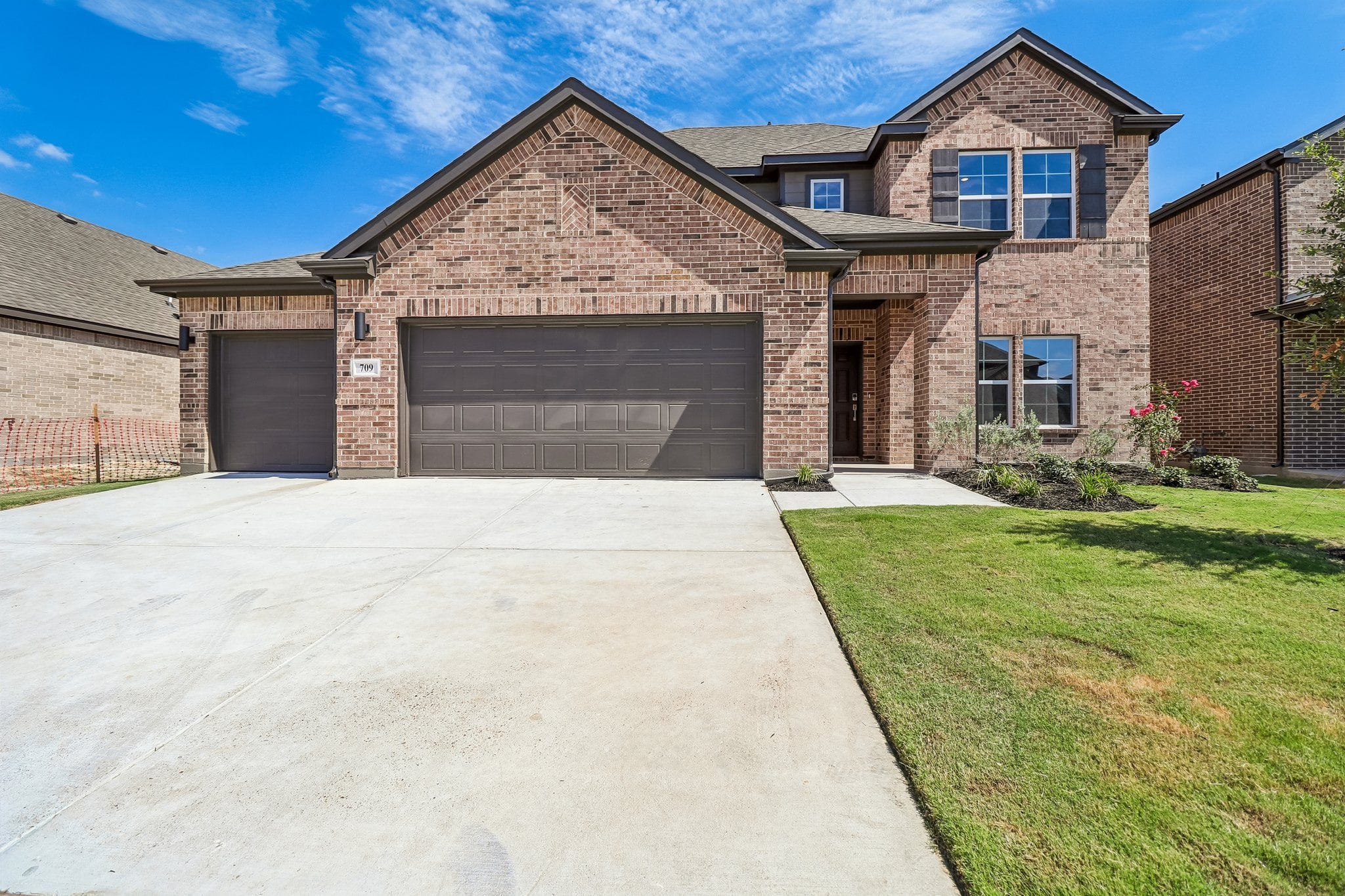 A brick building with a driveway.