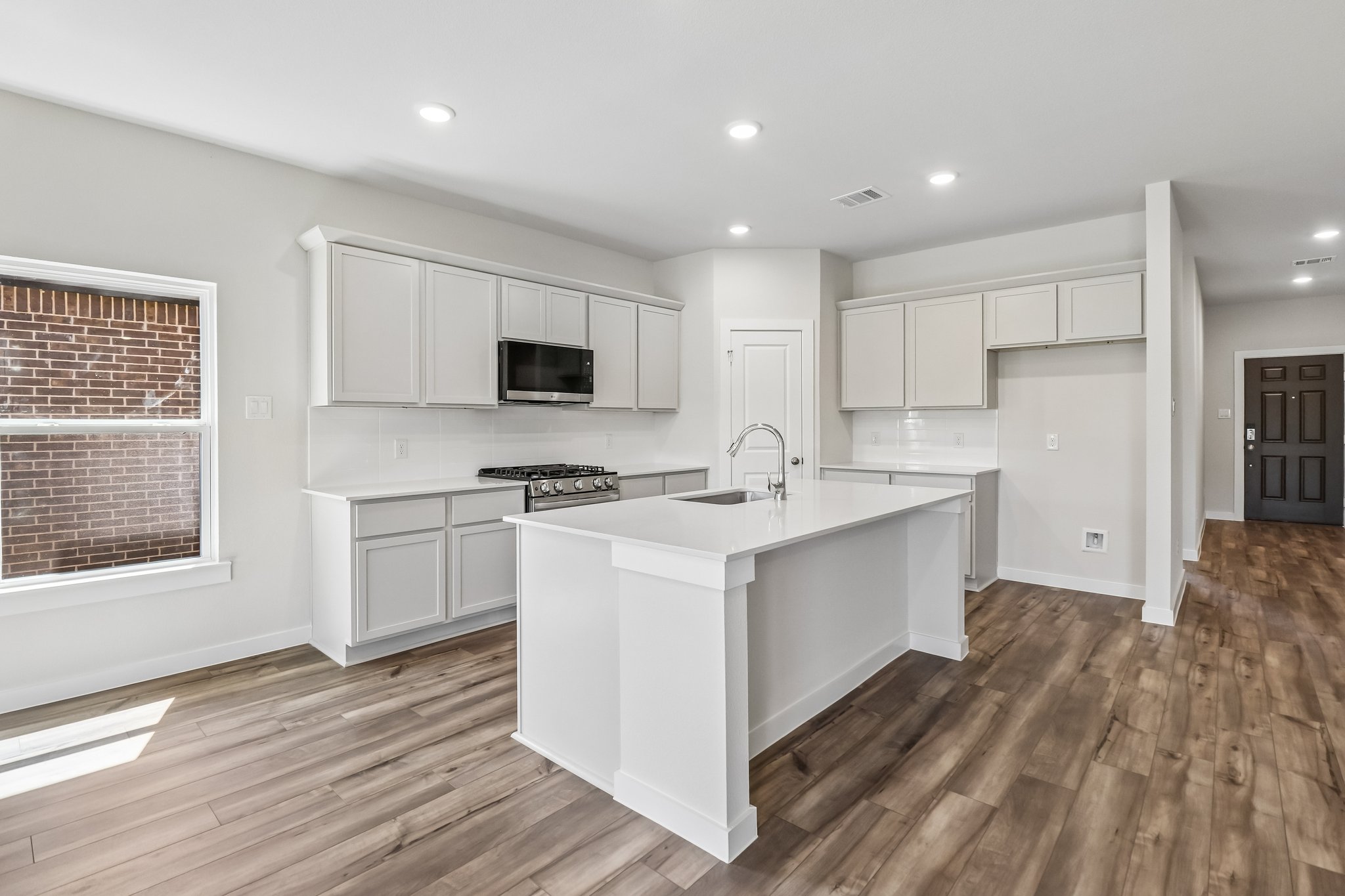 A kitchen with white cabinets.