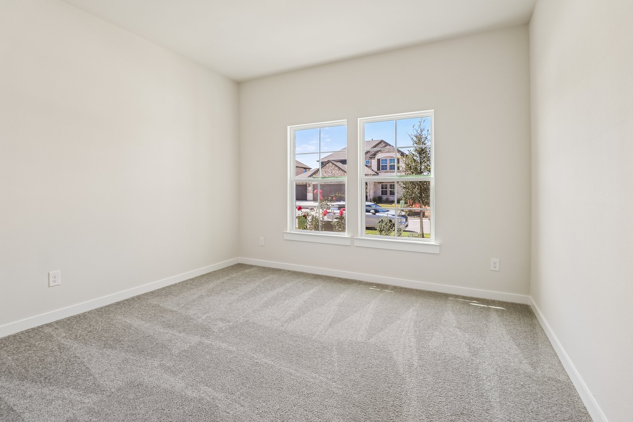 A room with a window and a carpet.