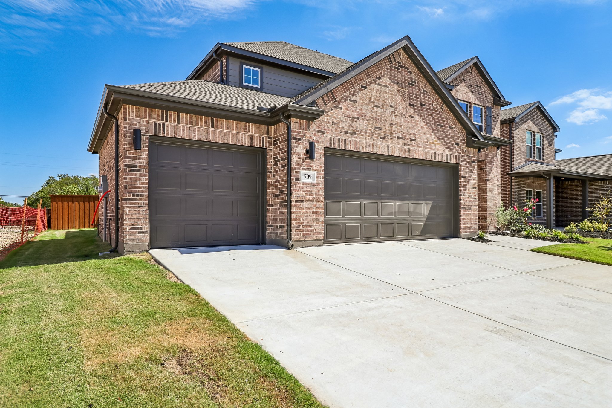 A house with garages and a driveway.