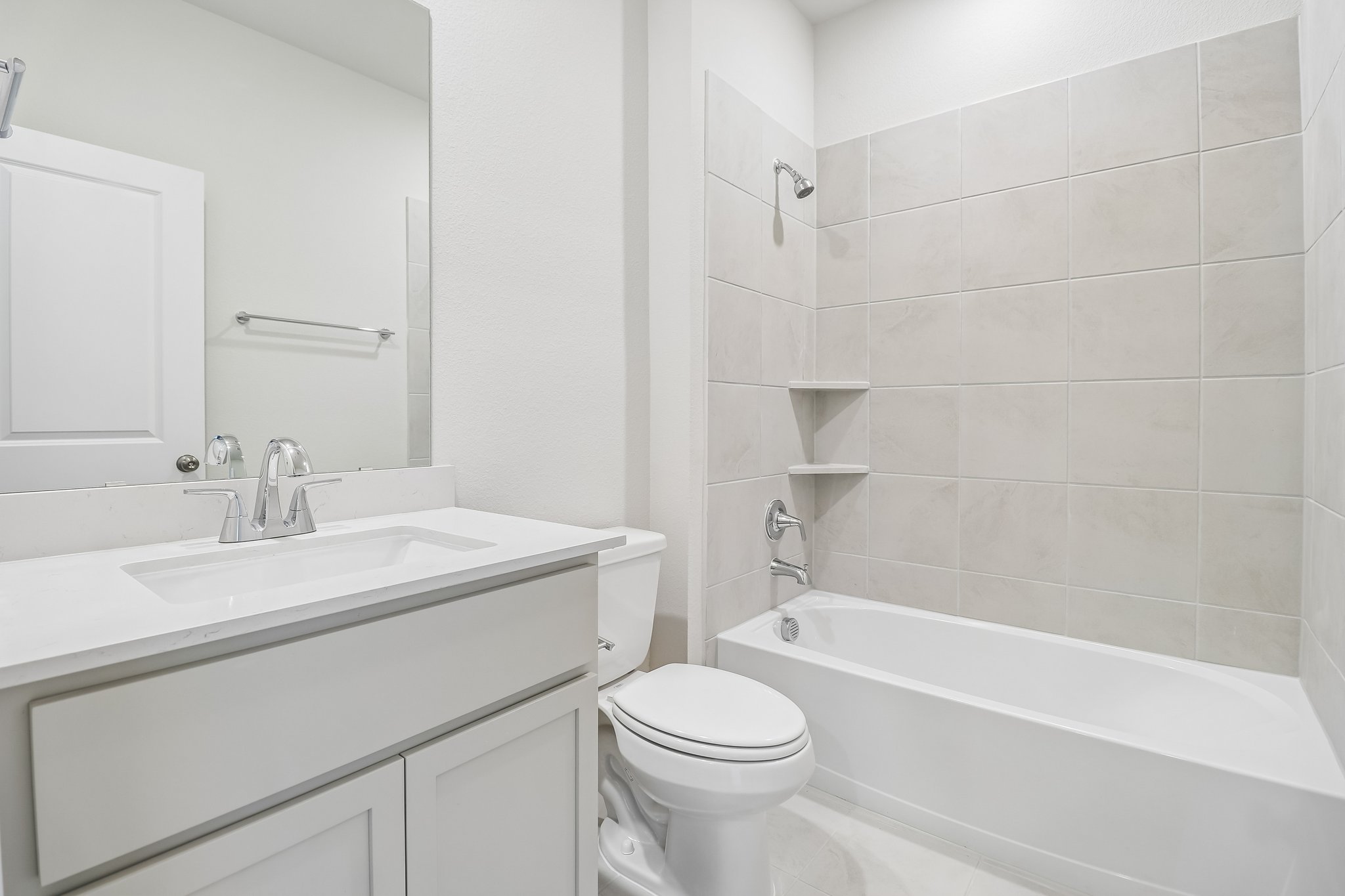 A bathroom with a tub sink and toilet.
