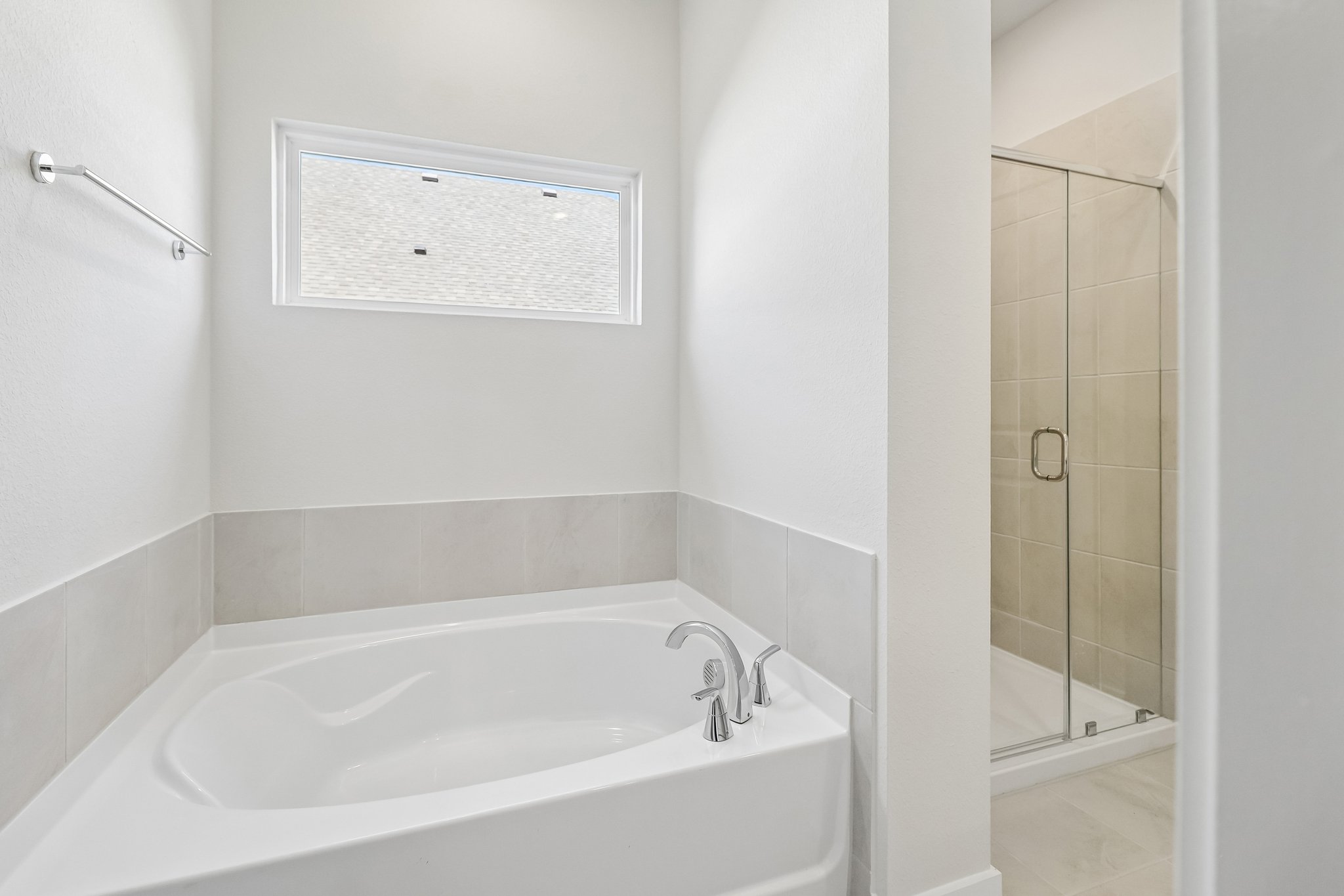 A bathroom with a bathtub and shower.