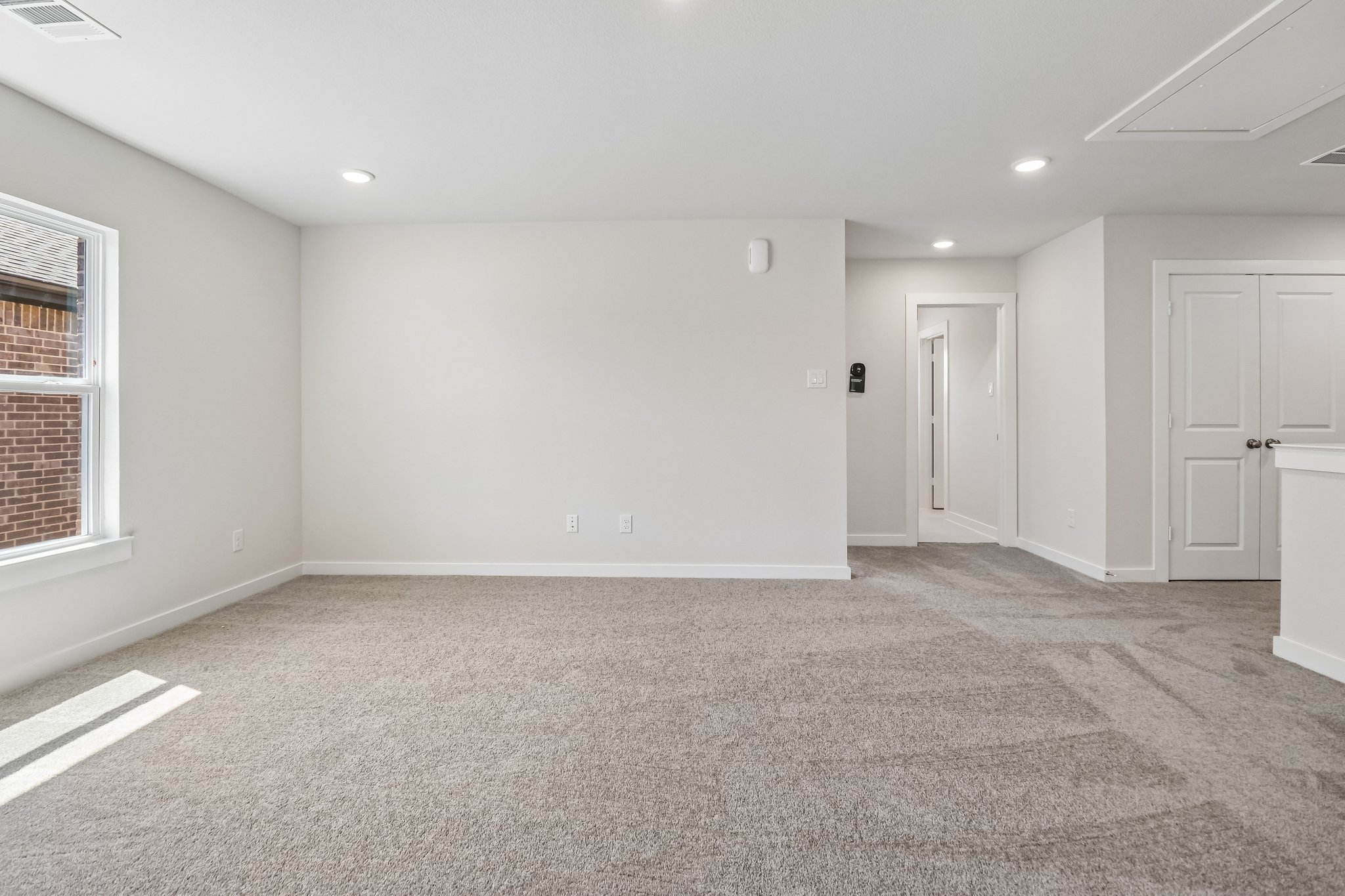 A room with white walls and a carpeted floor.