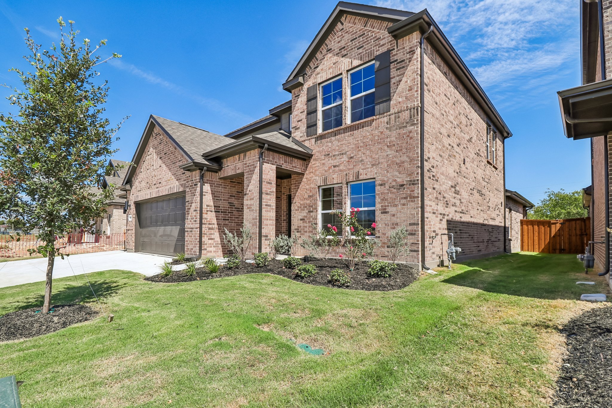 A brick house with a yard.
