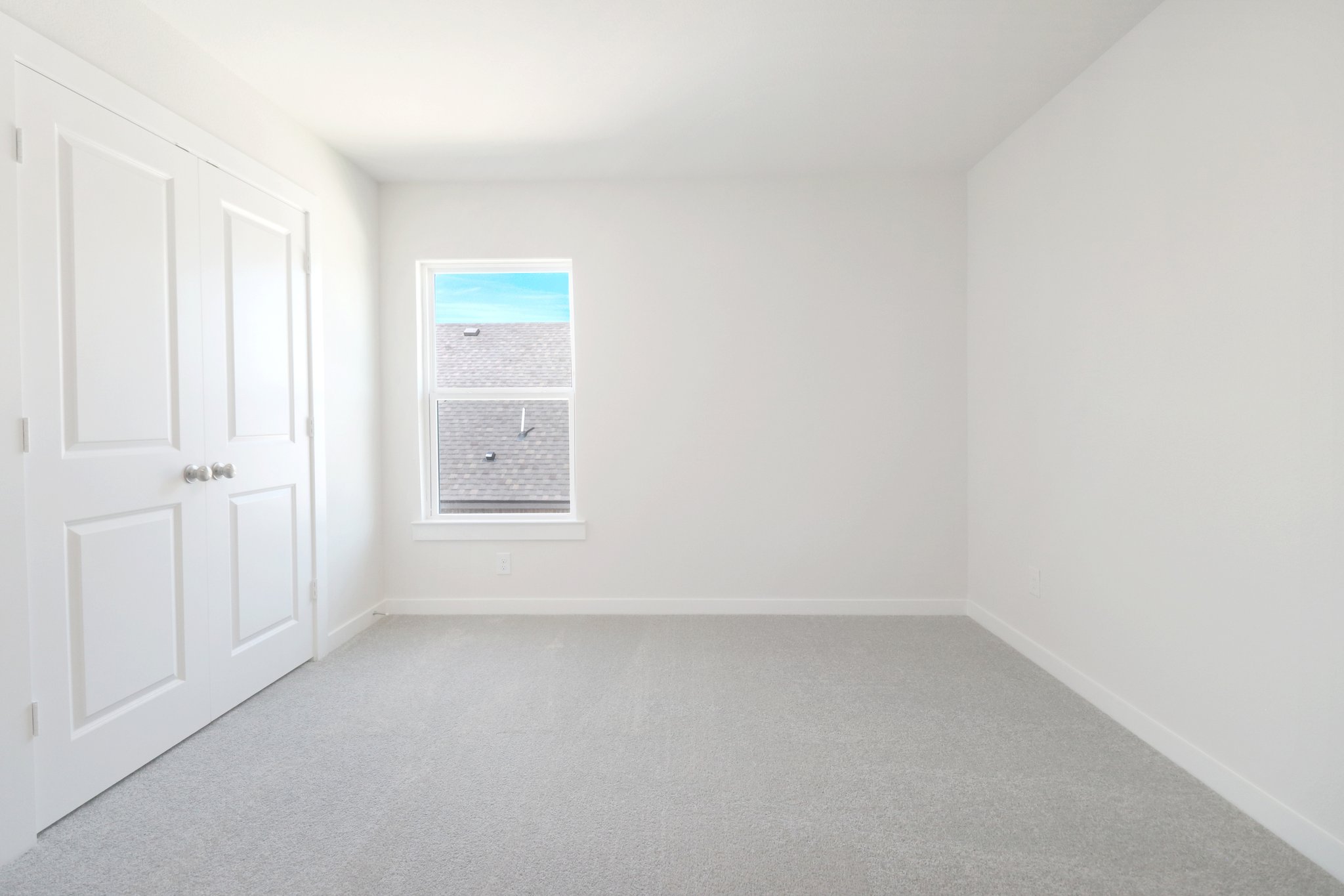 A hallway with white doors.