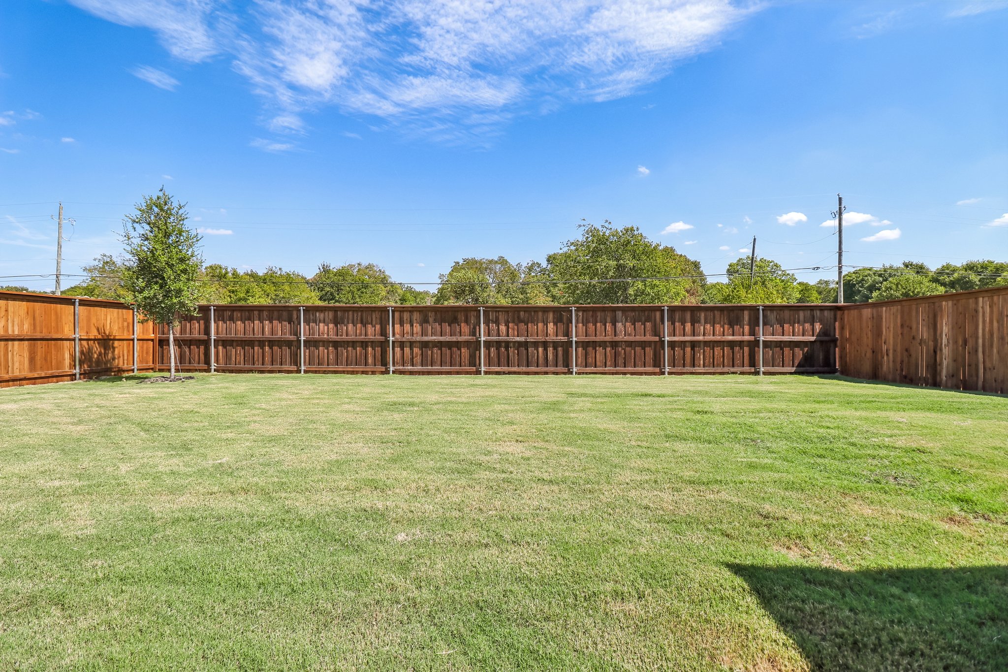 A fenced in grass field.