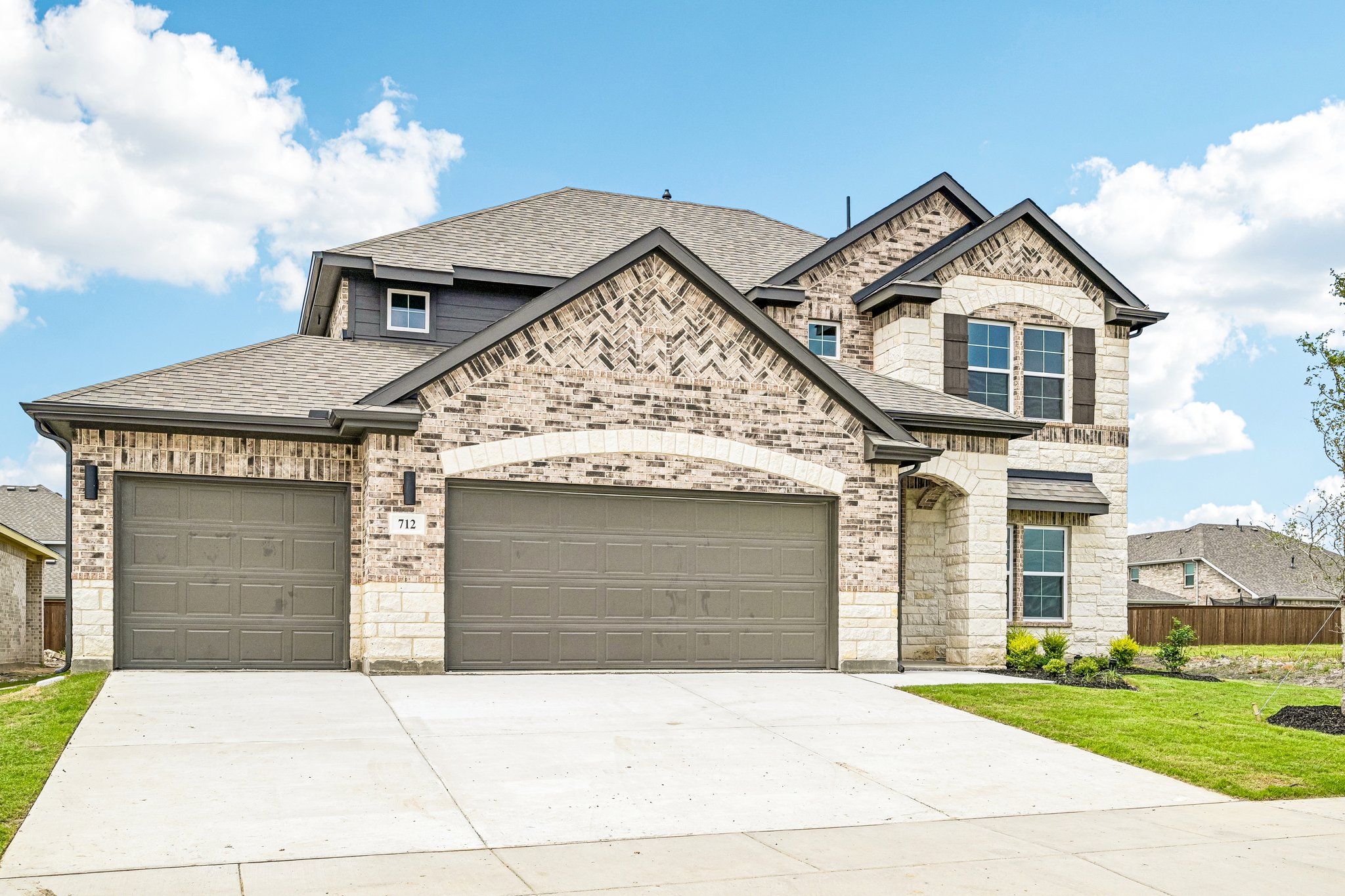 A house with garages and a driveway.