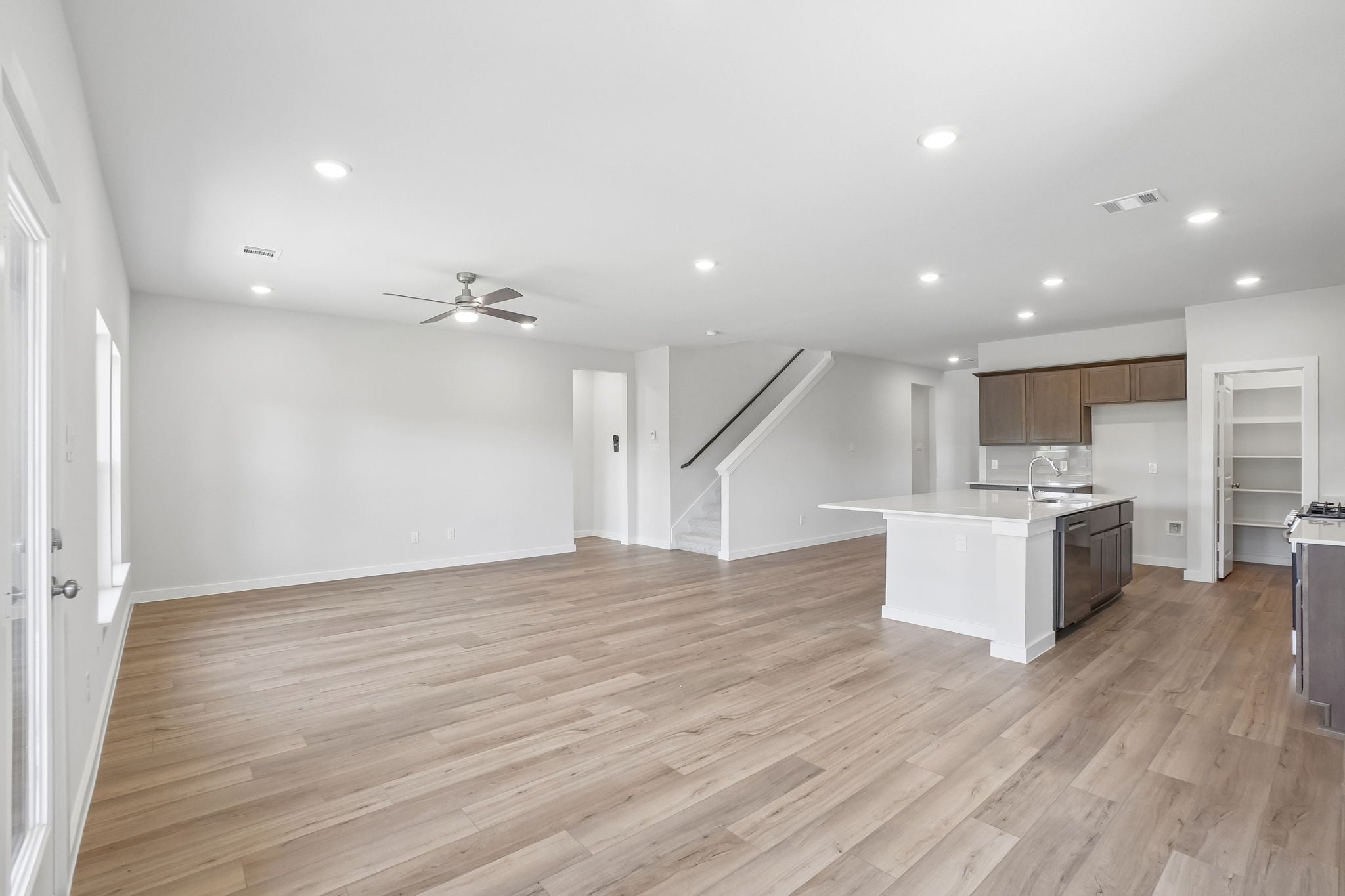 A large kitchen with wooden floors.