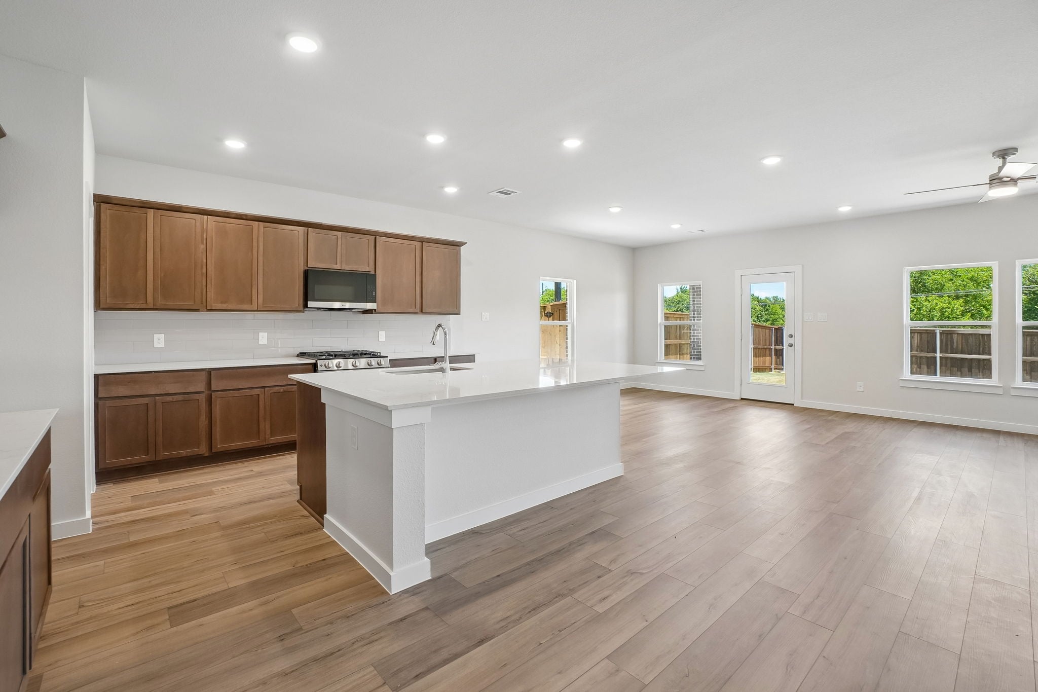A kitchen with wooden cabinets.