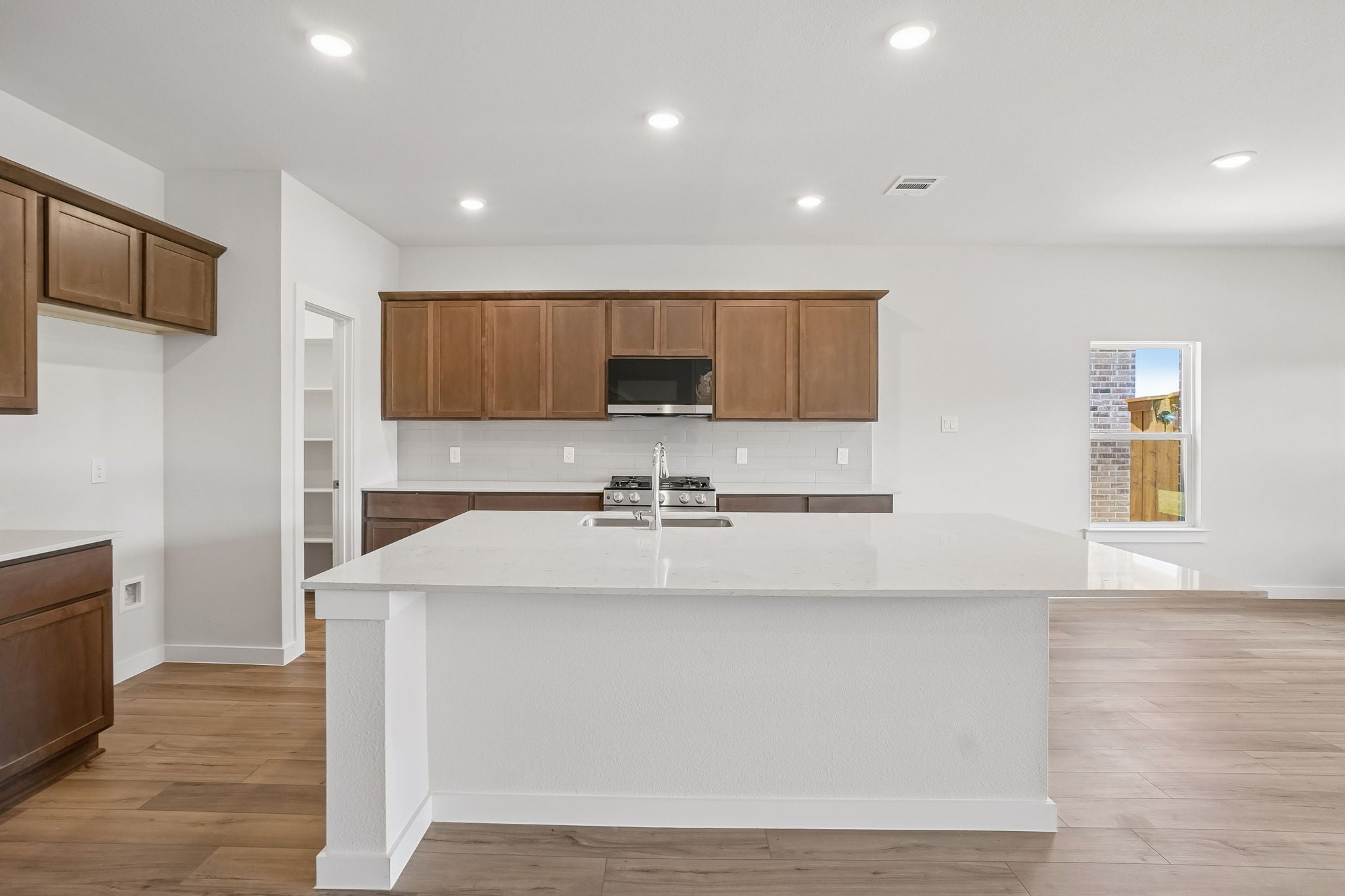 A kitchen with wooden cabinets.