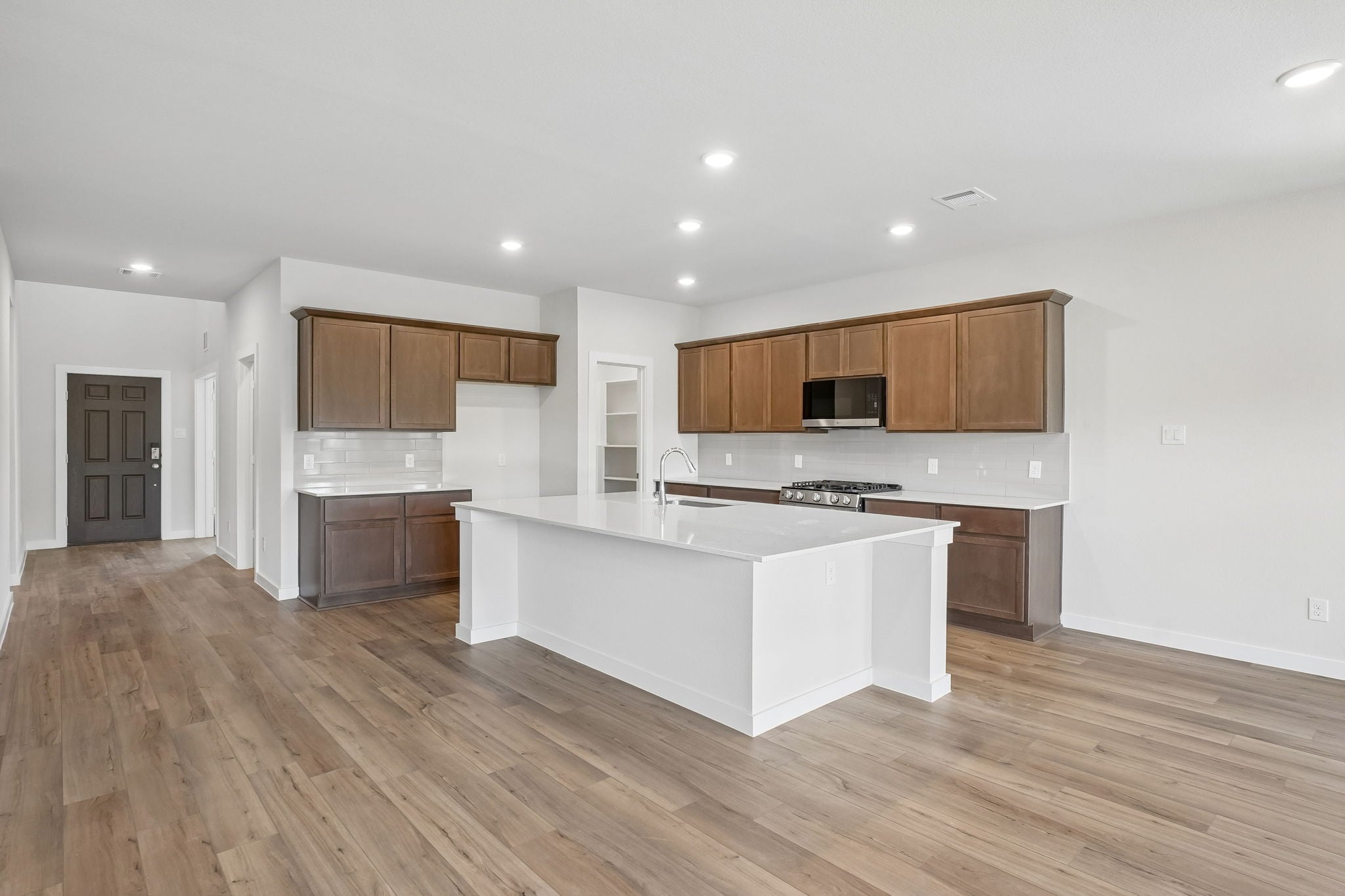 A kitchen with wooden cabinets.