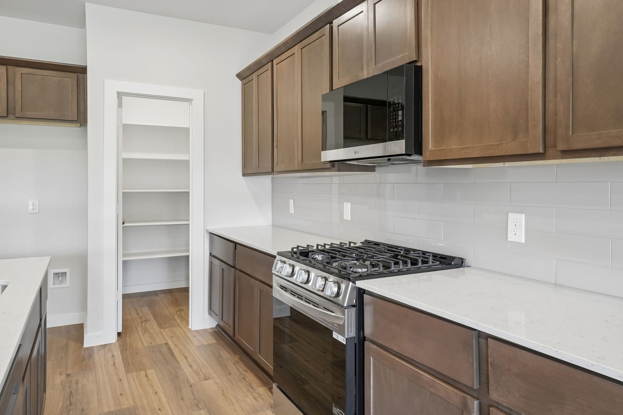 A kitchen with wooden cabinets.