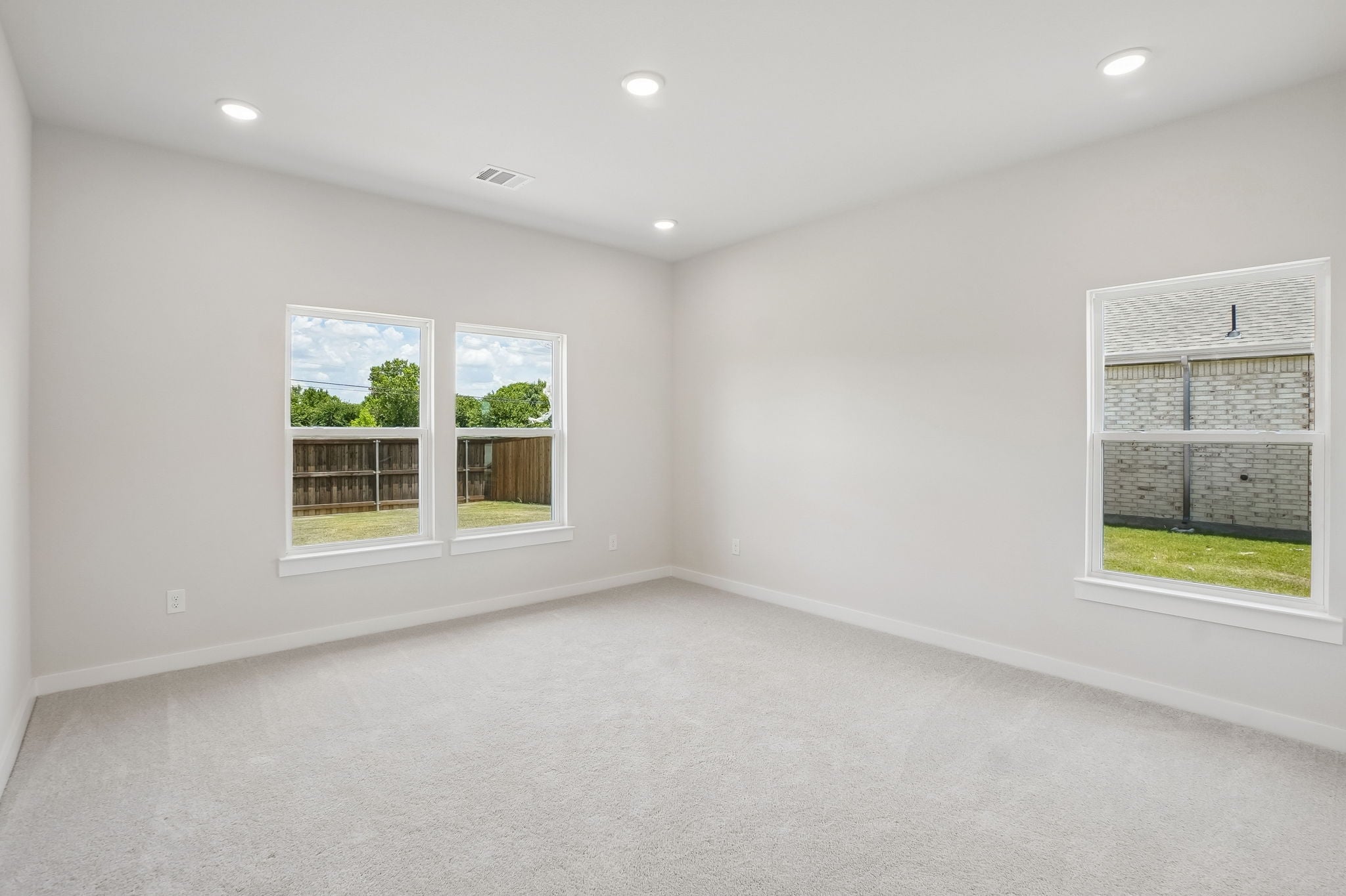 A room with a window and a white wall with a white floor.