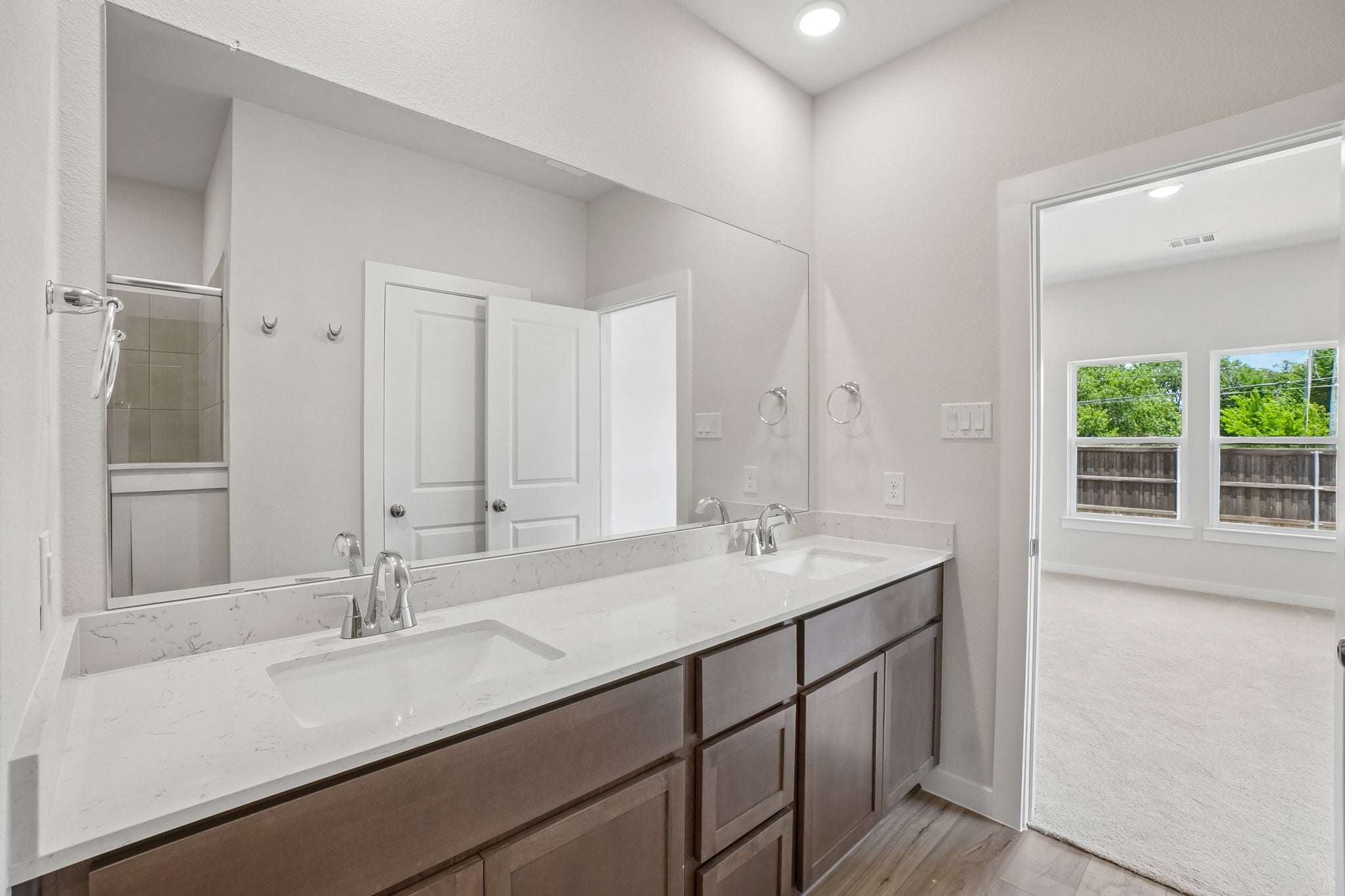 A bathroom with a large mirror.