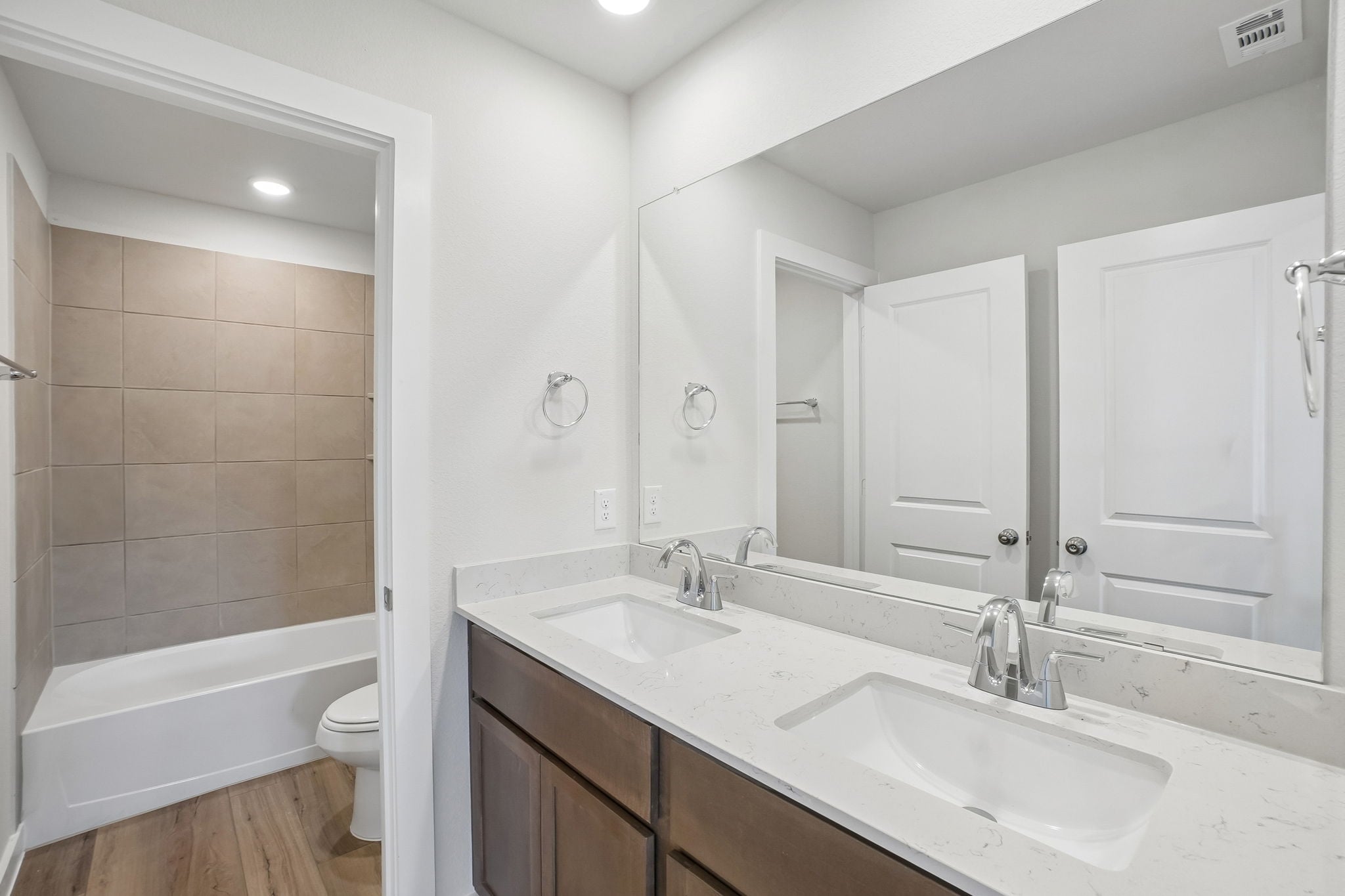 A bathroom with a tub sink and toilet.