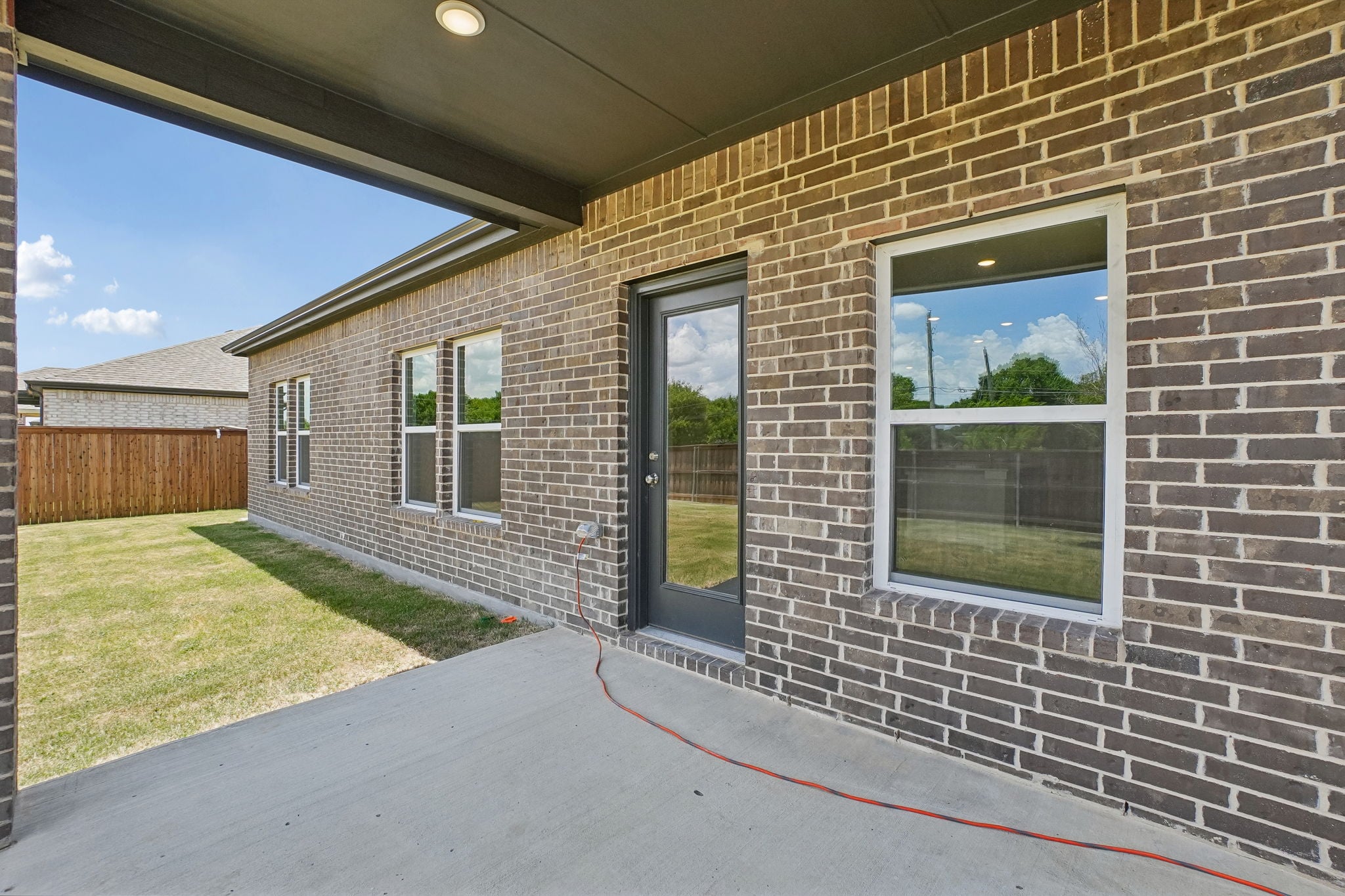 A brick building with a red rope.
