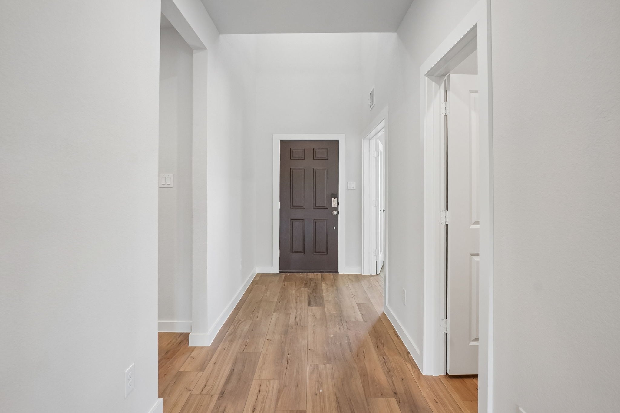 A hallway with white doors.