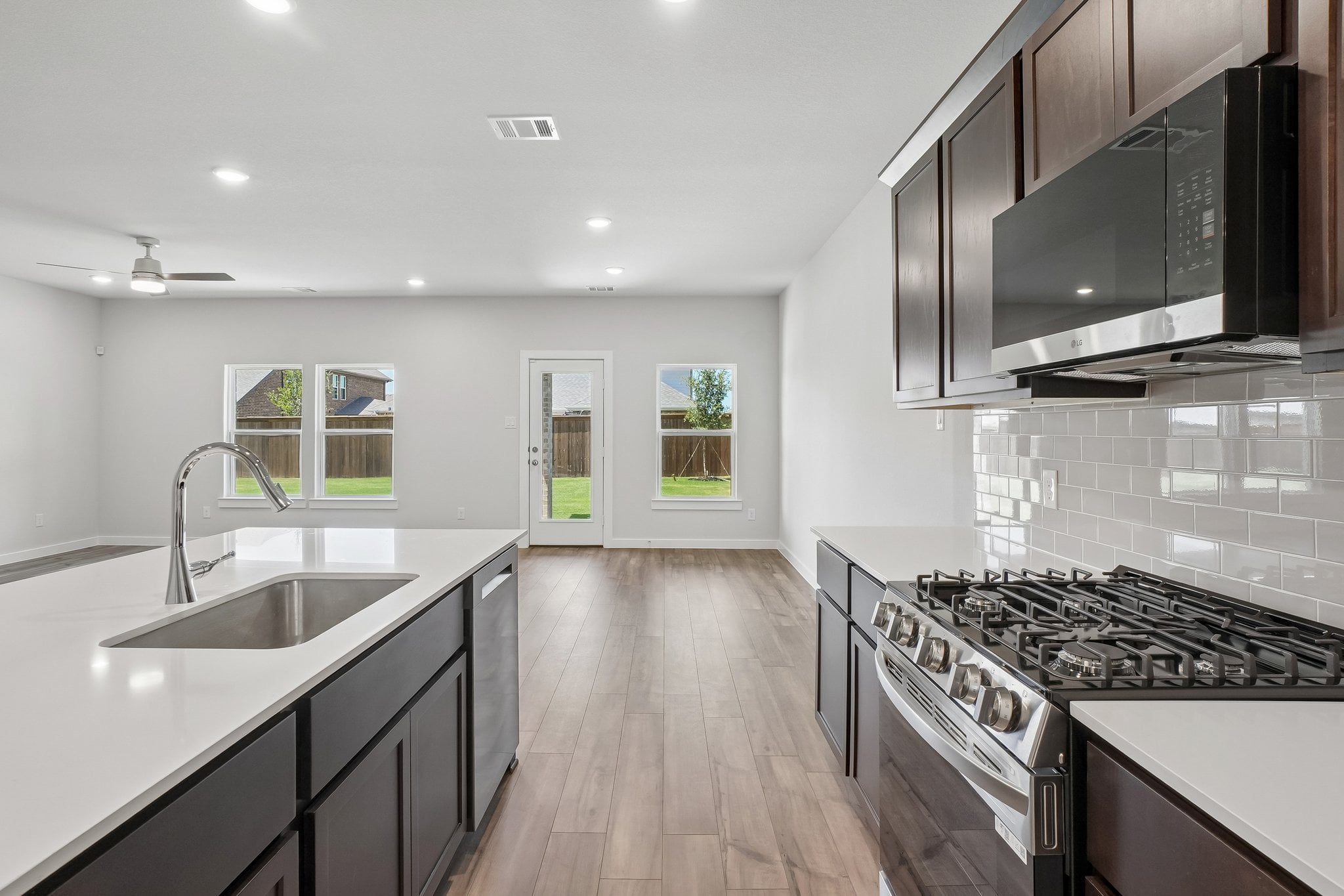 A kitchen with black cabinets.