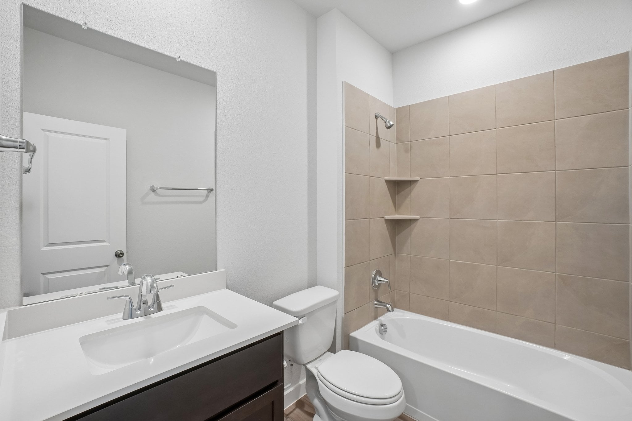 A bathroom with a tub sink and toilet.