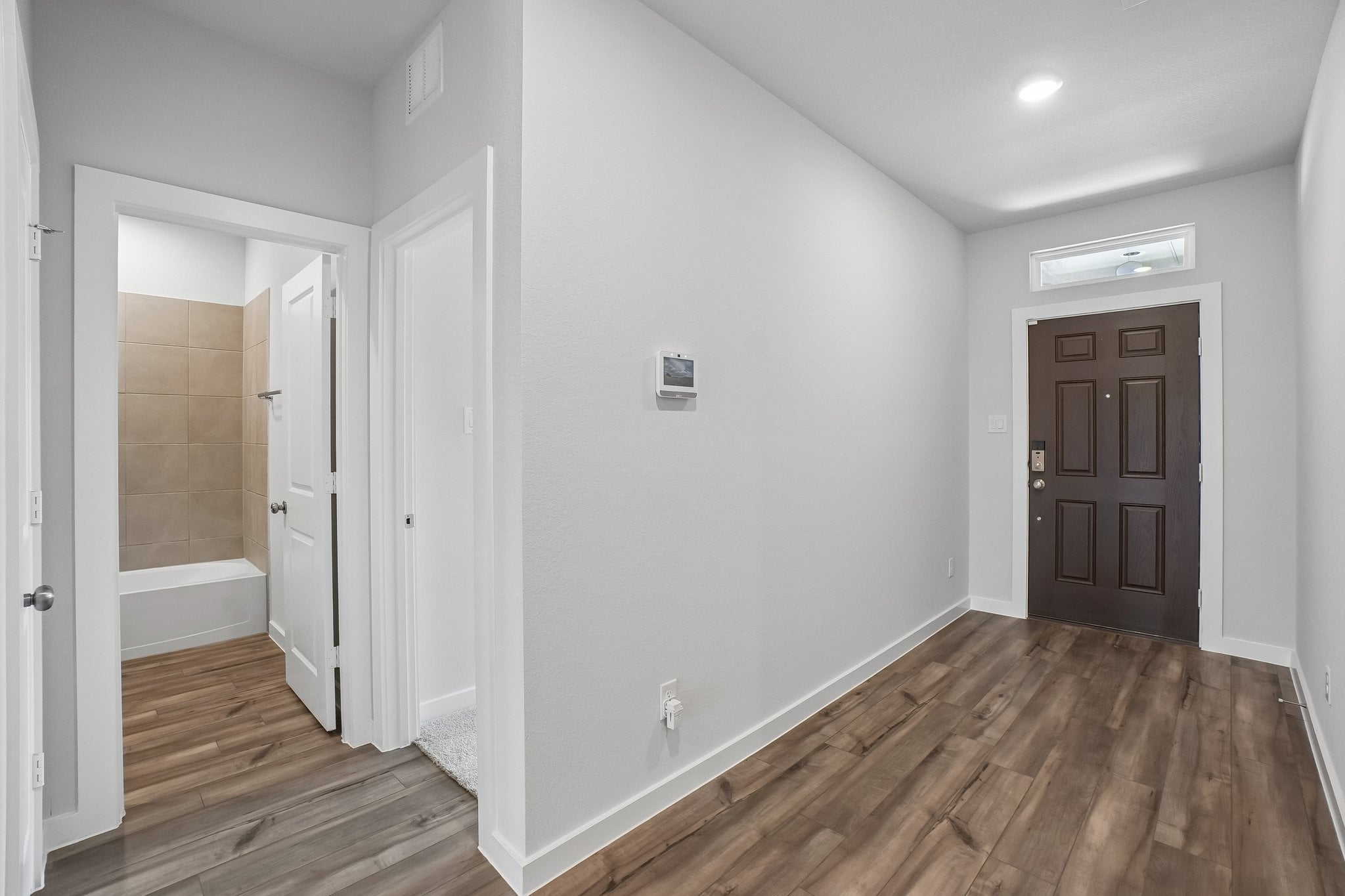 A bathroom with a wood floor.