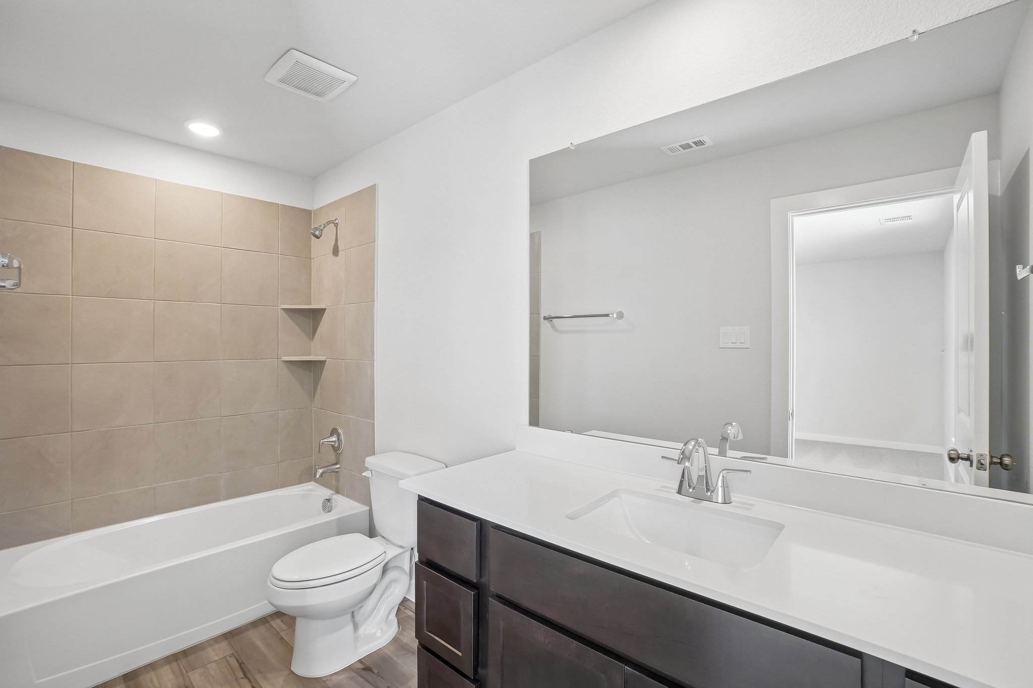 A bathroom with a tub sink and toilet.