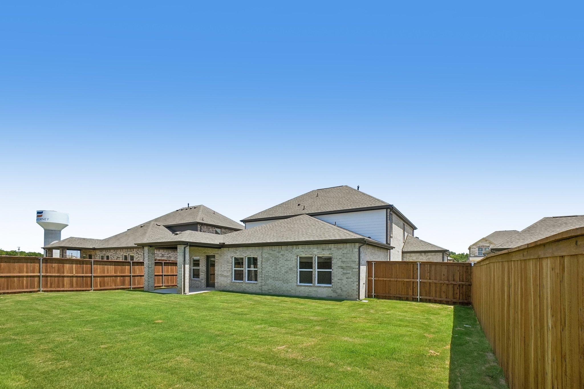 A house with a fence and grass.