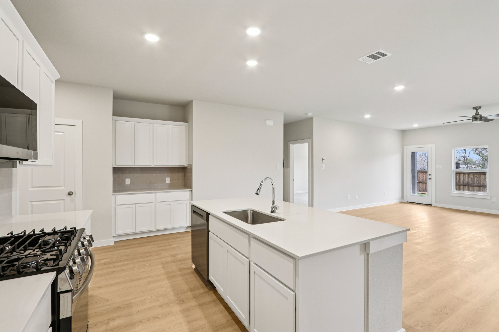 A kitchen with white cabinets.
