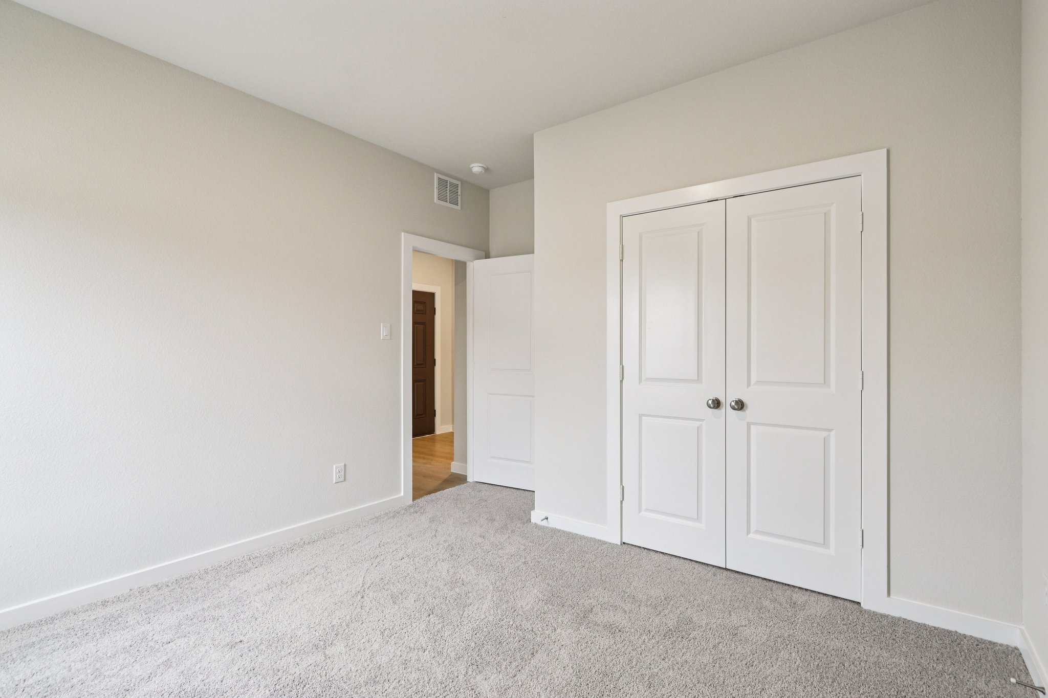 A hallway with white doors.