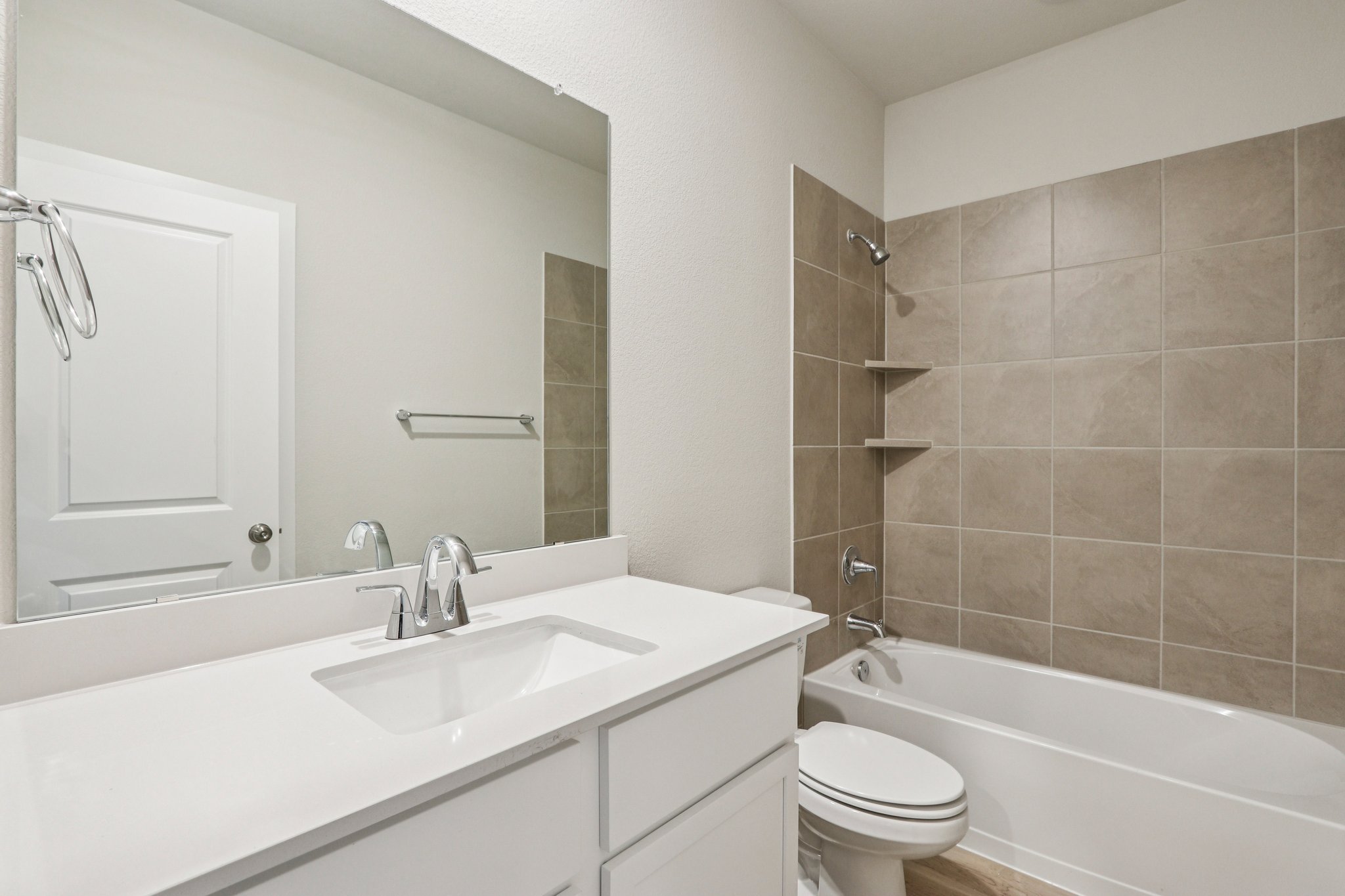 A bathroom with a tub sink and toilet.
