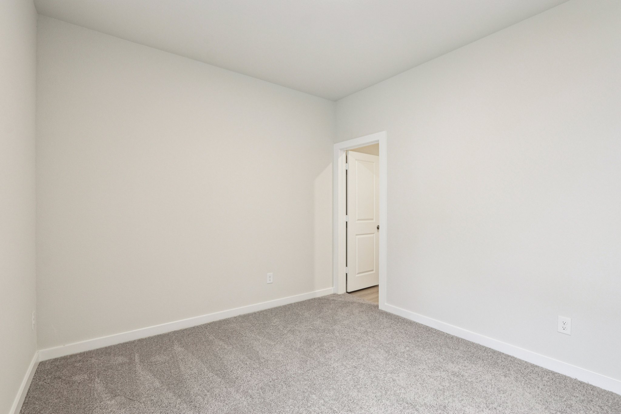 A hallway with white walls.