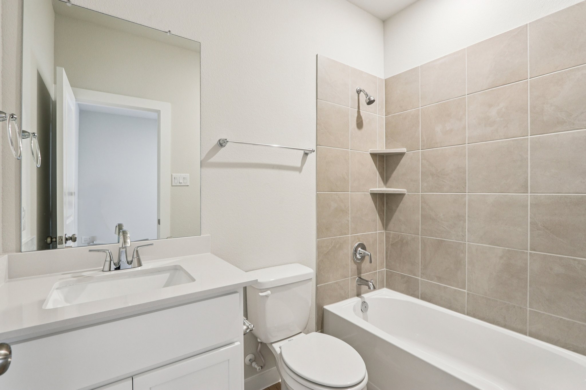 A bathroom with a tub sink and toilet.