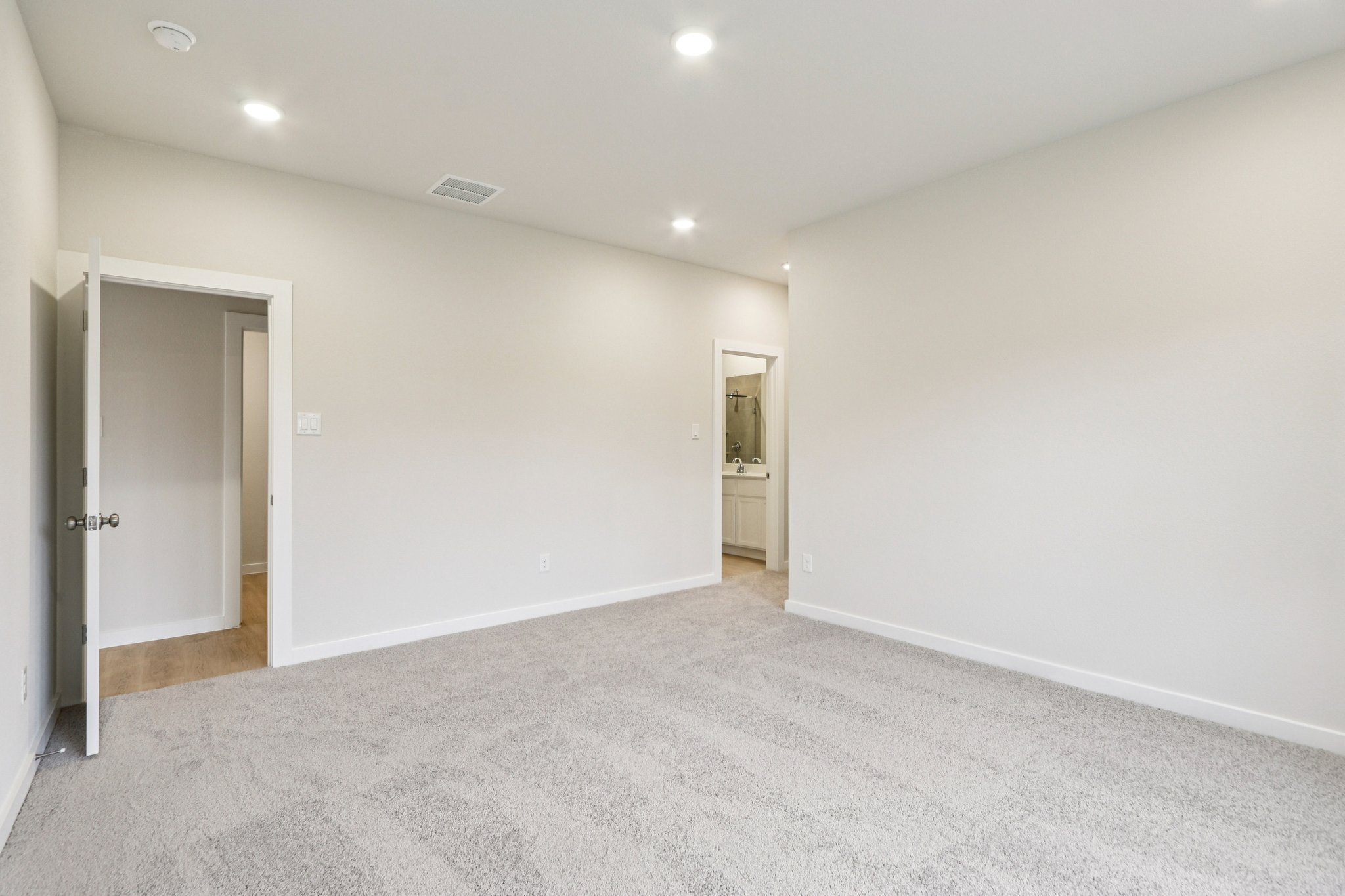 A hallway with white walls.